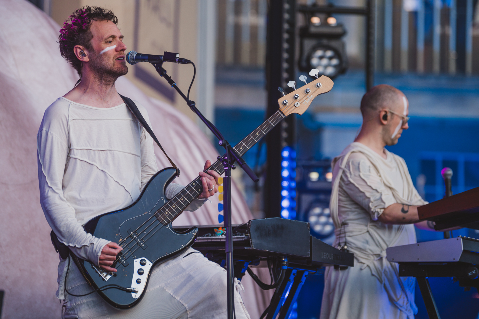 Musicians performing on stage with guitar and keyboard