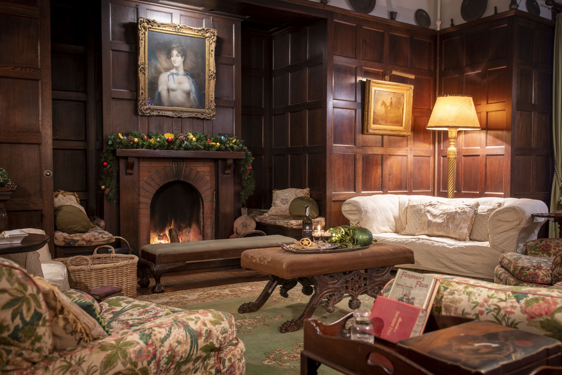 Cozy living room with wood paneling and fireplace