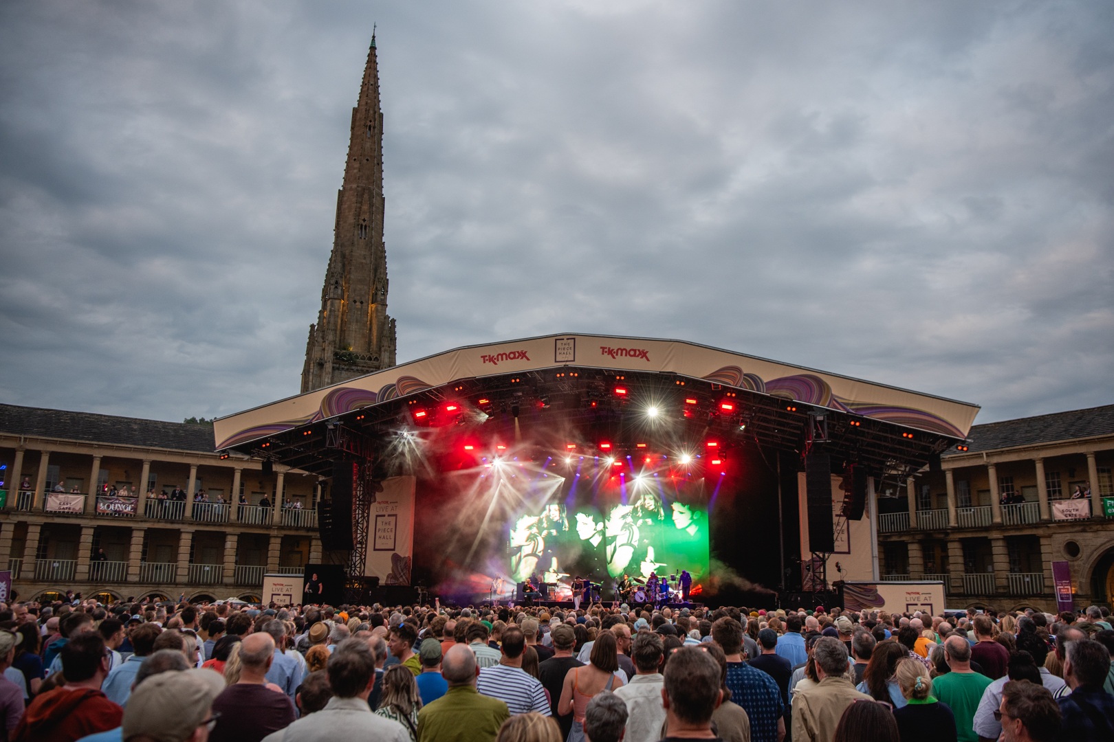 Evening concert at Piece Hall with illuminated stage and crowd