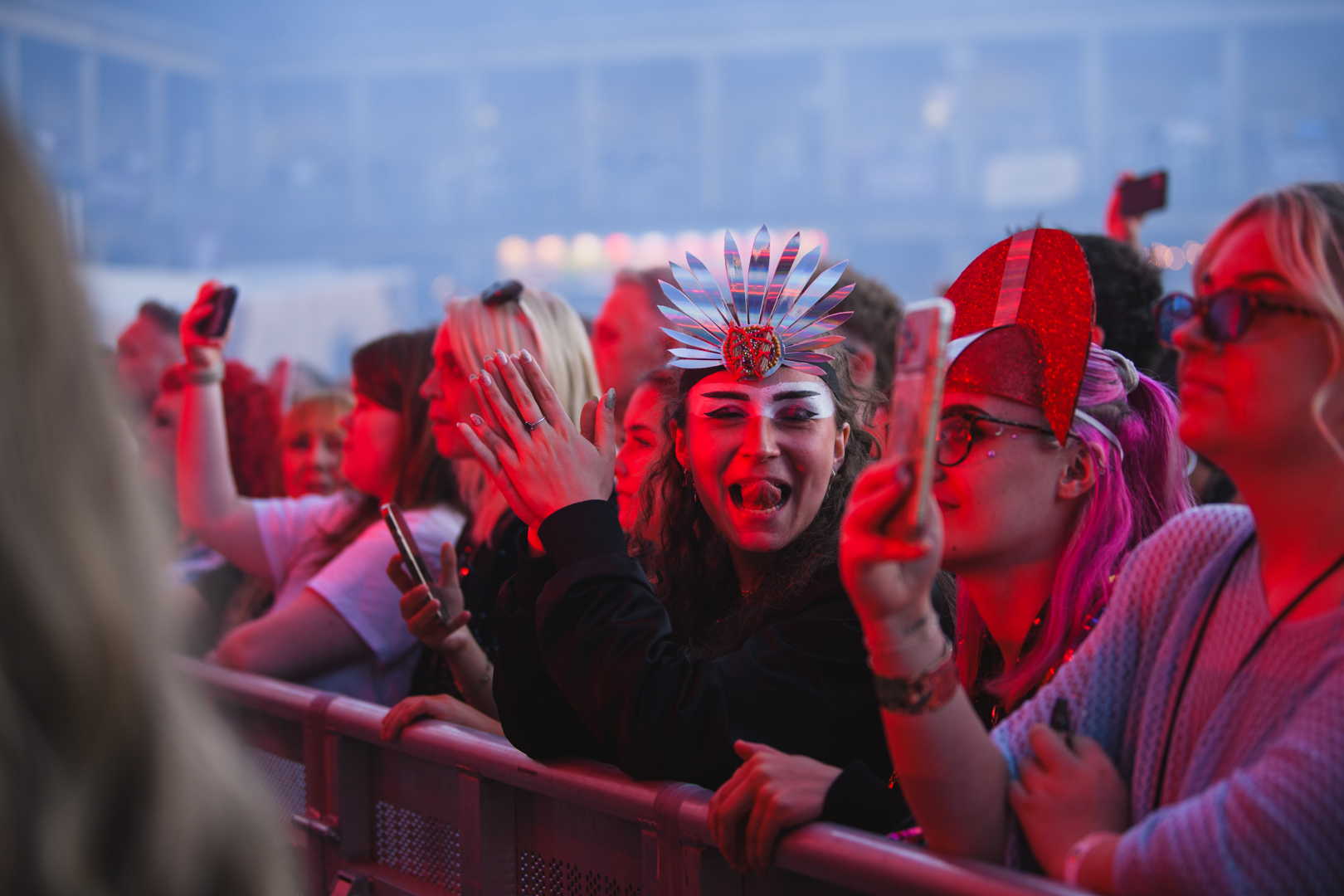 Crowd at a lively music festival in Yorkshire with colorful lights