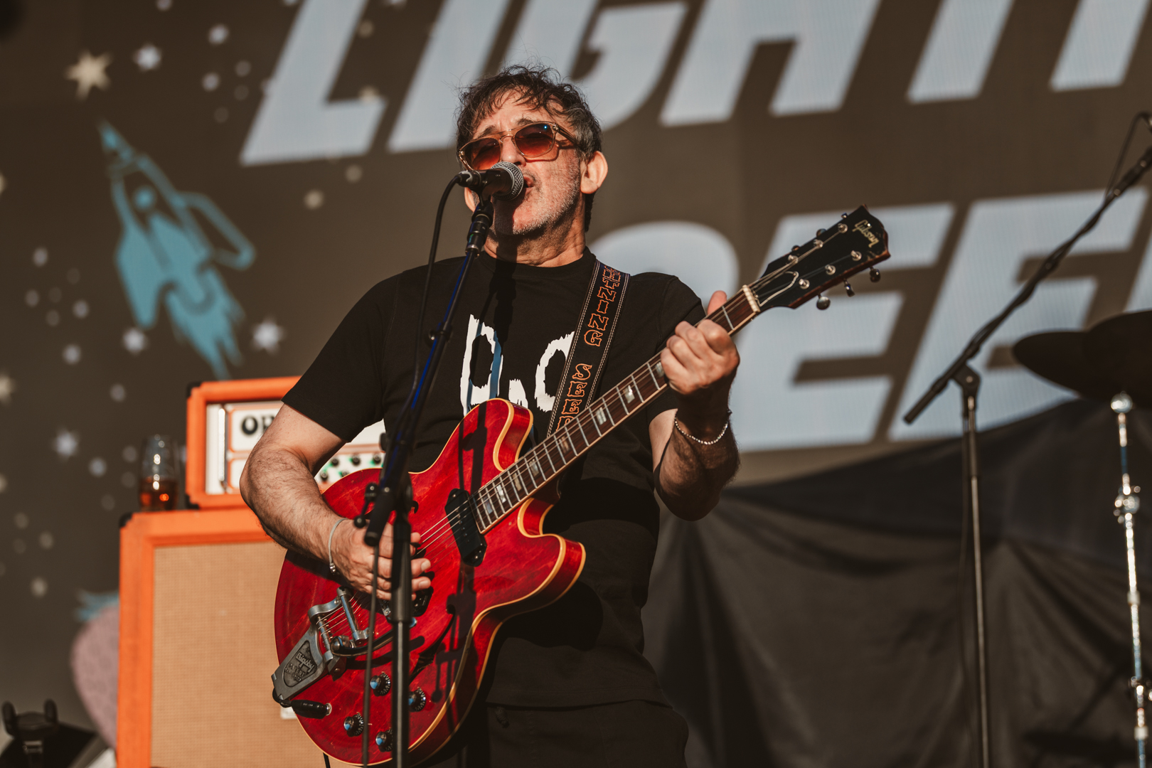 Musician playing electric guitar on outdoor stage