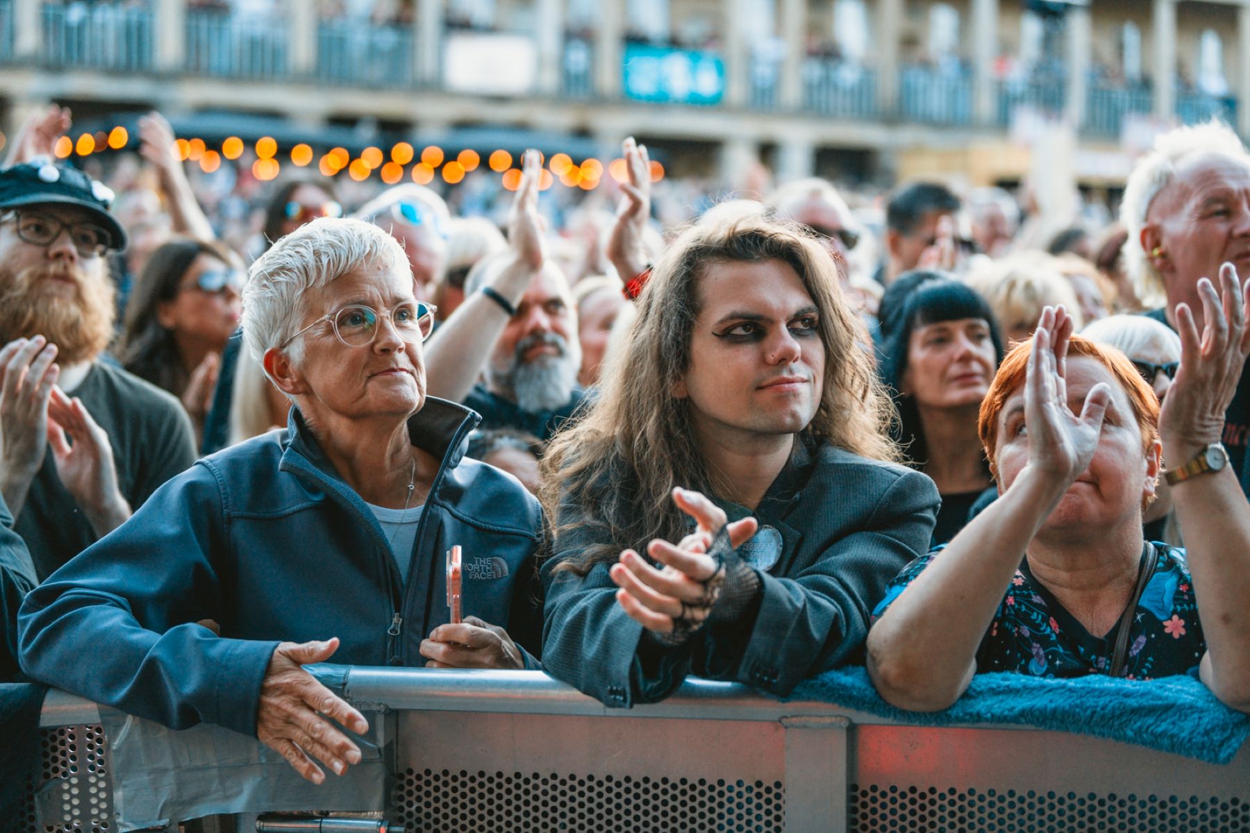 Crowd enjoying outdoor music festival with diverse audience