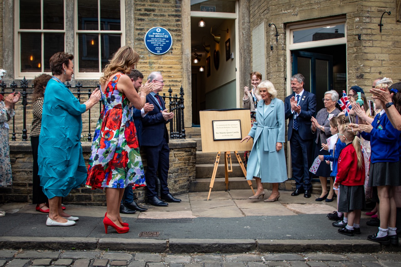 Group gathered outside historic stone building for plaque unveiling