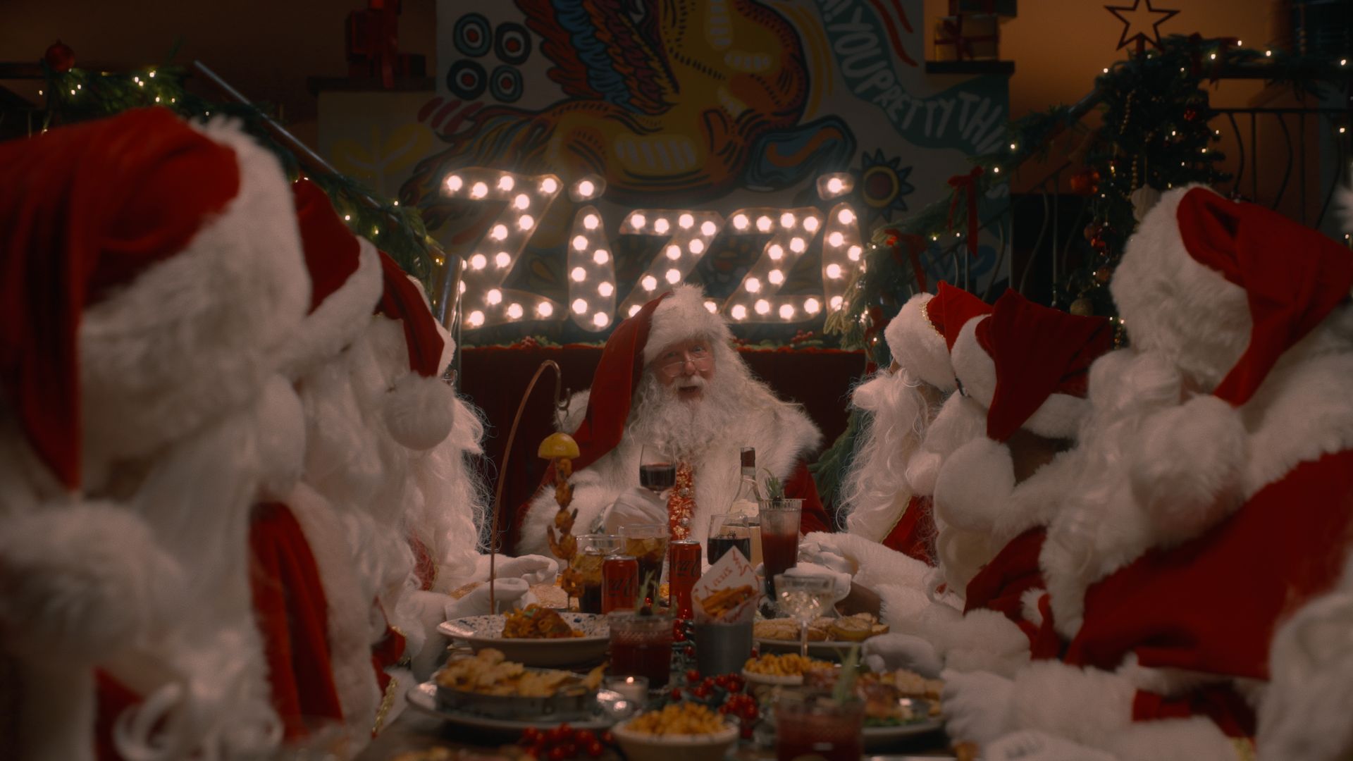 Group of people dressed as Santa enjoying a festive meal