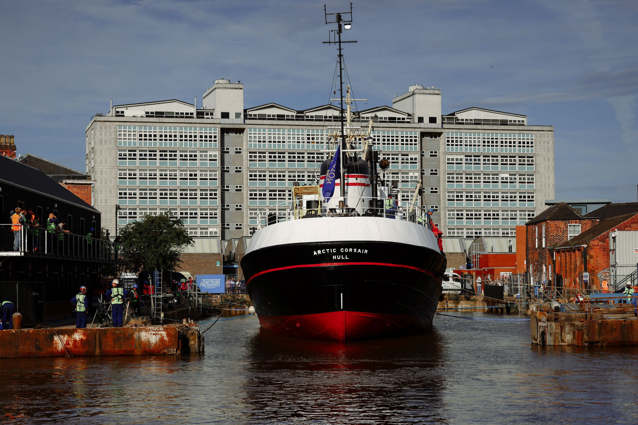 Historic ship moored in front of modern building in Hull