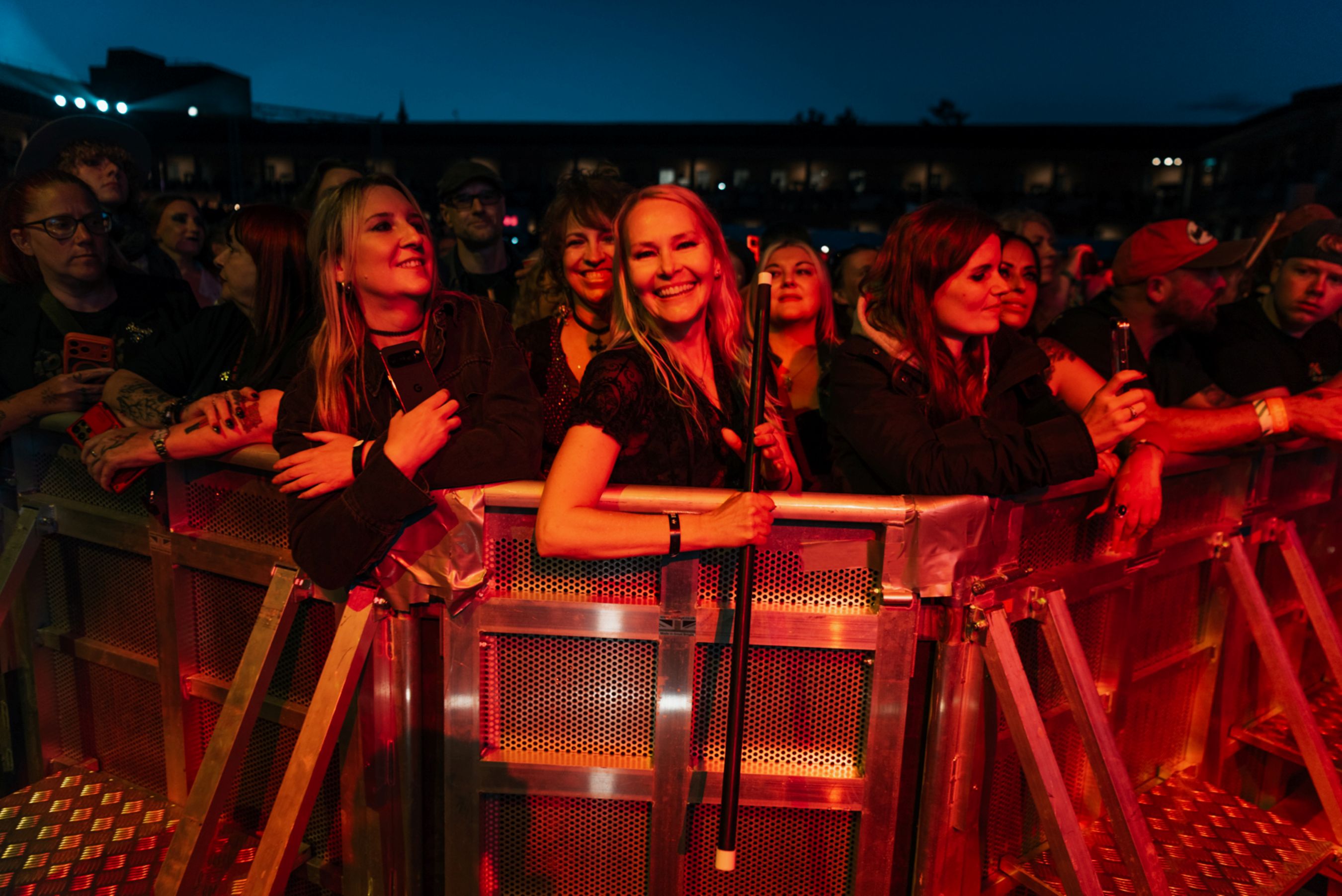 Crowd of smiling concertgoers at an outdoor music festival