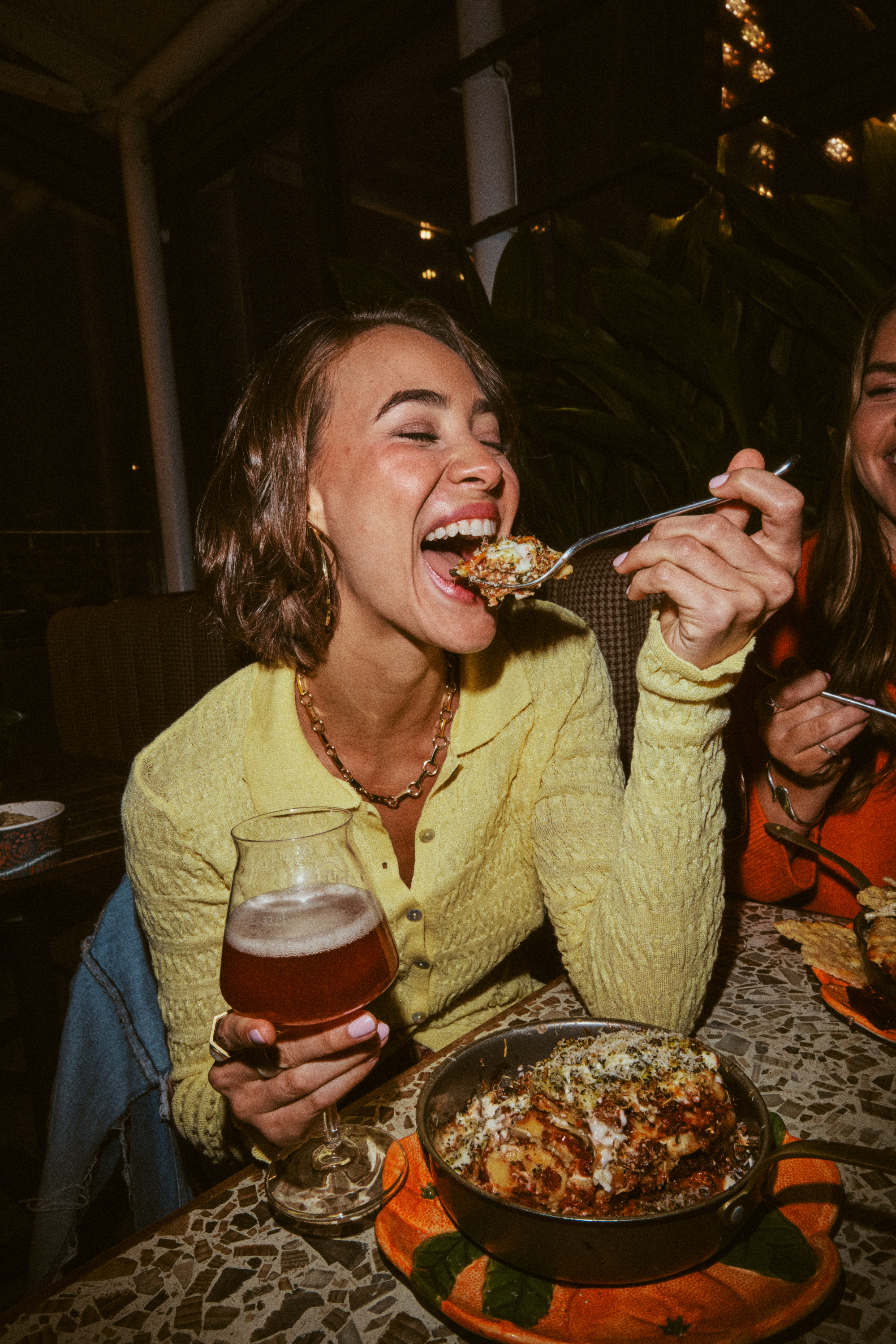 Woman enjoying meal and beer at a cozy Yorkshire pub