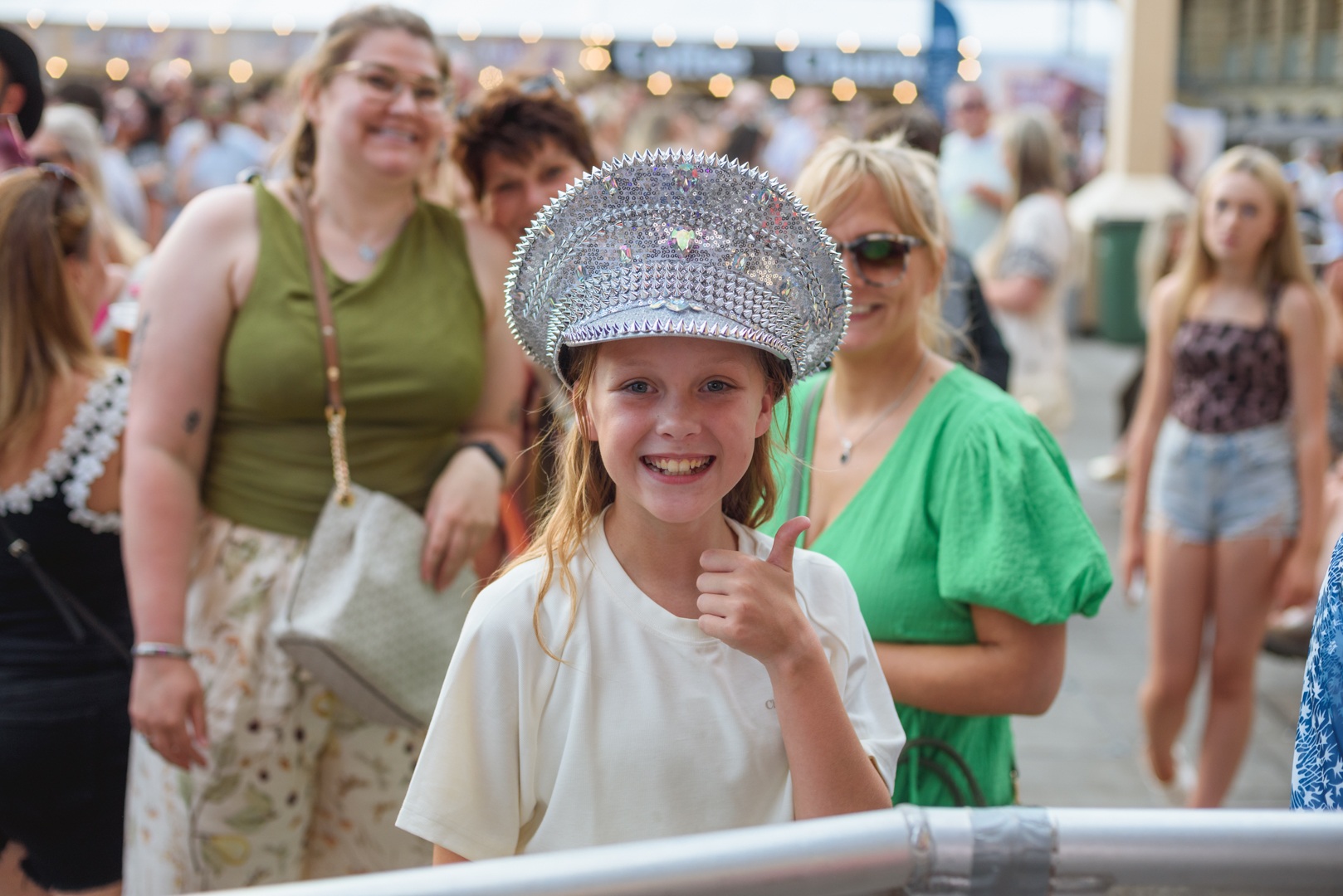 Smiling girl in sparkly hat giving thumbs up at festival - ELLIE SAXX AT THE PIECE HALL
