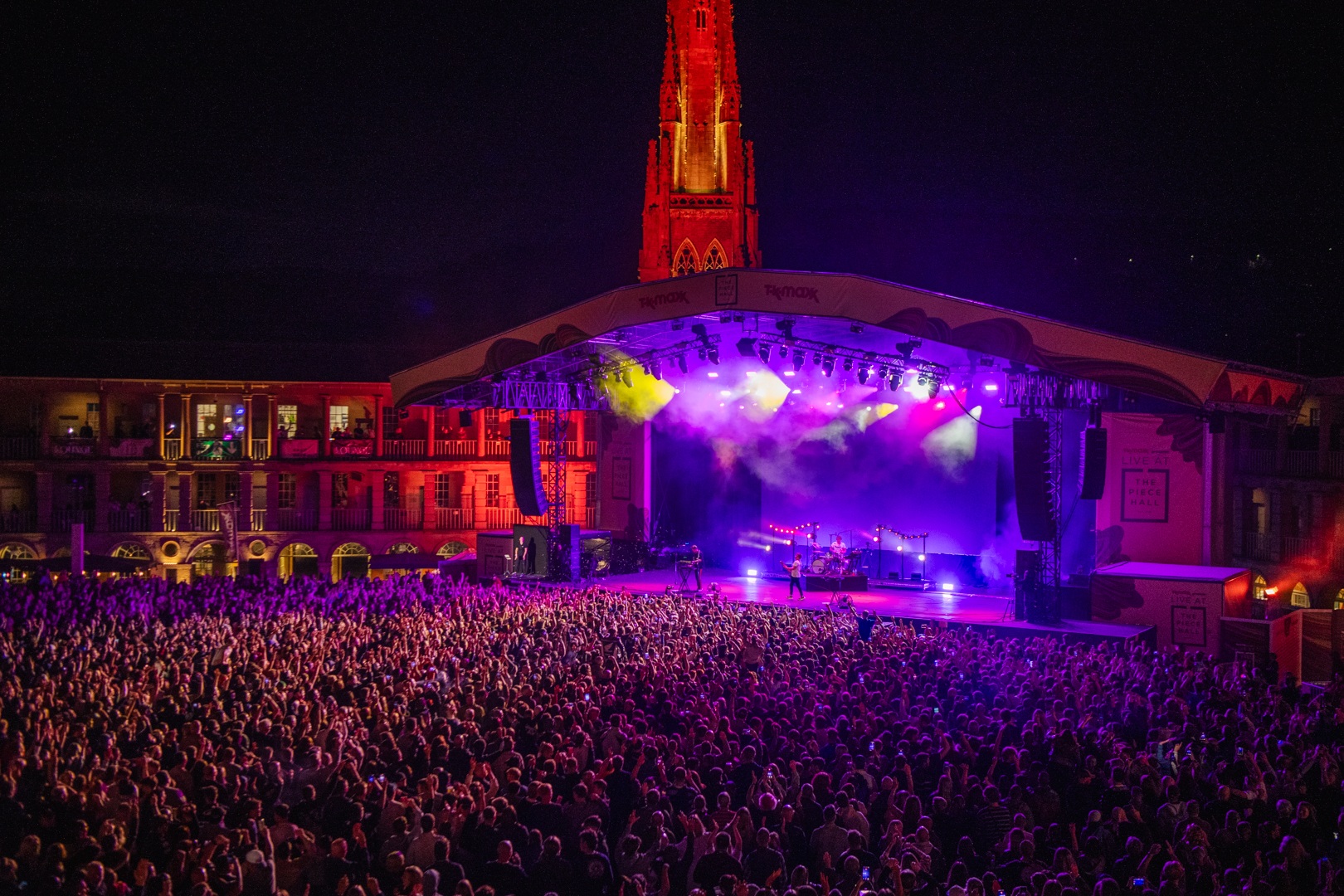 Nighttime concert at Scarborough Open Air Theatre with vibrant lighting