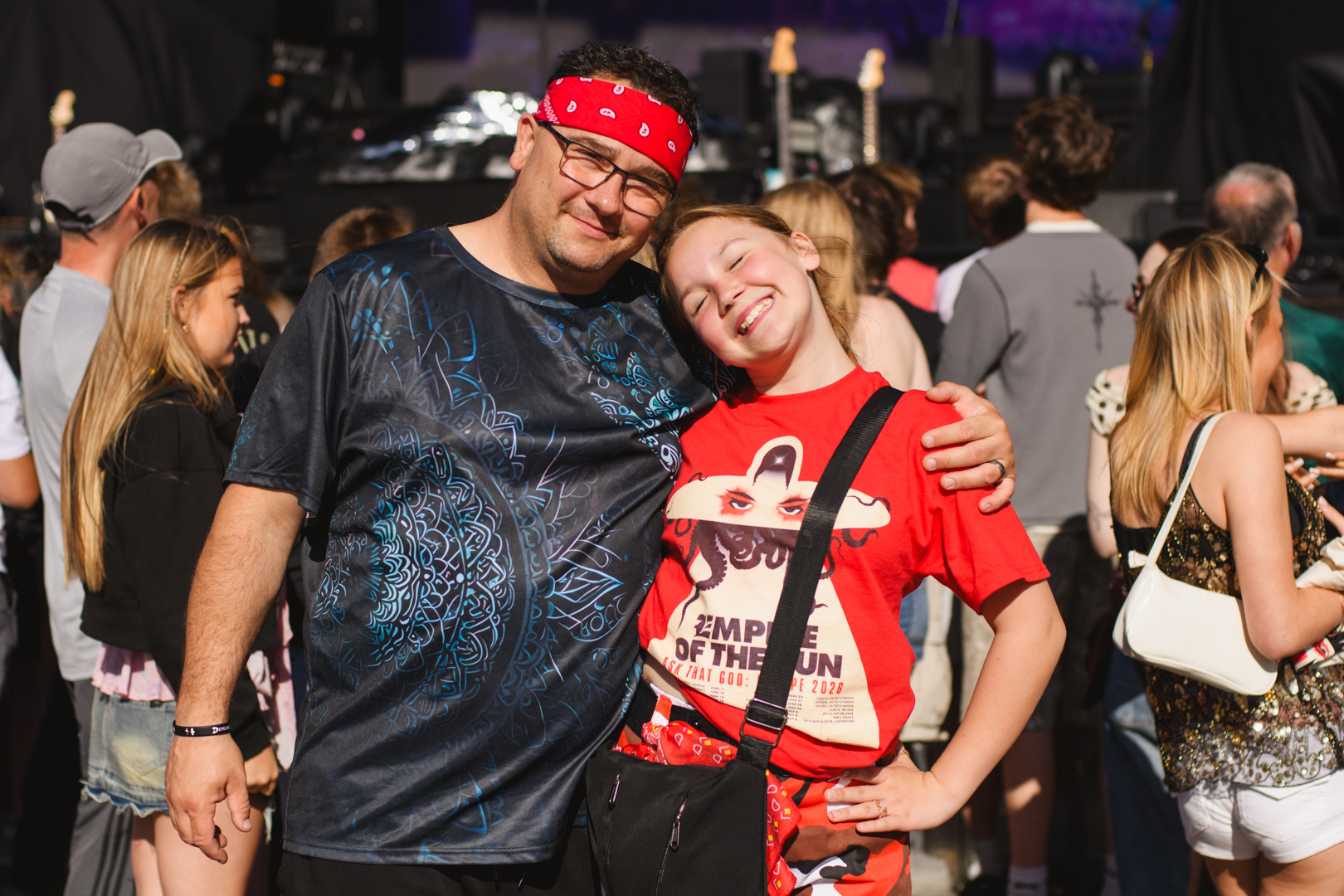 Smiling father and daughter at outdoor music festival
