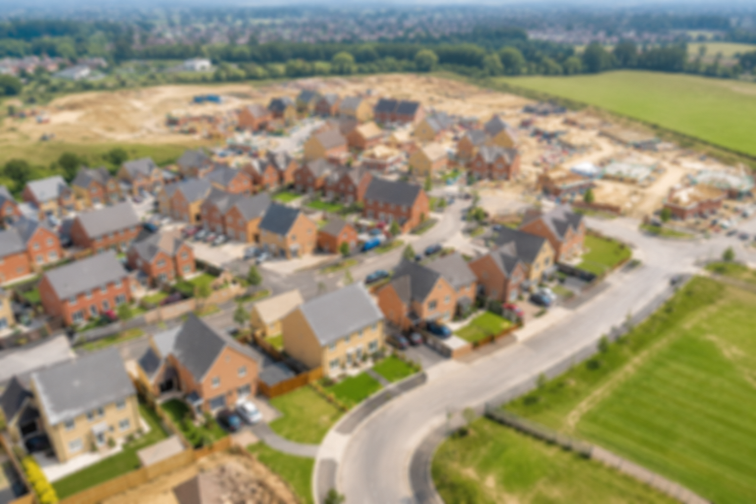 Aerial view of suburban housing development with green fields