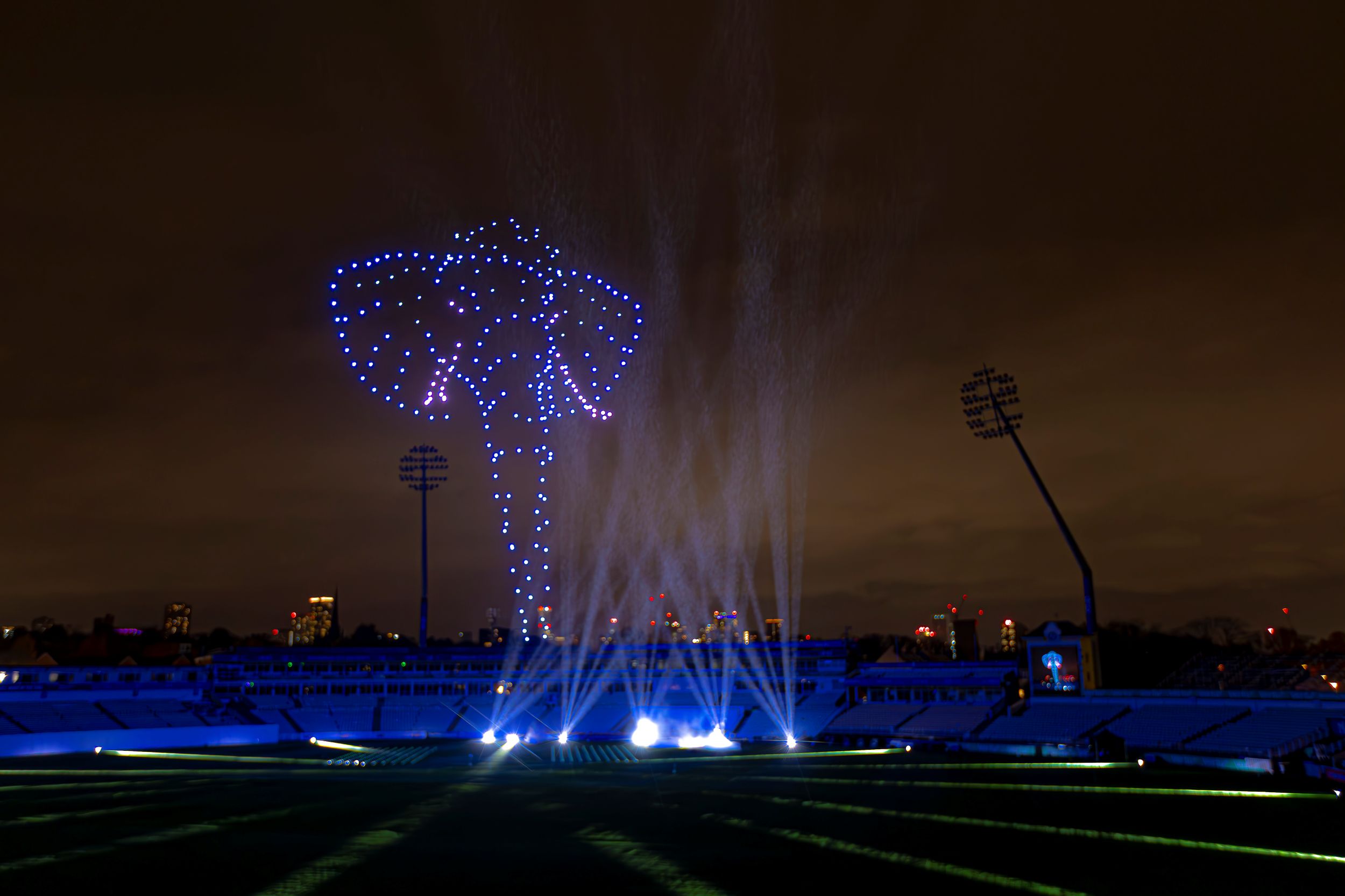 Night sky illuminated by drone light display forming Yorkshire rose