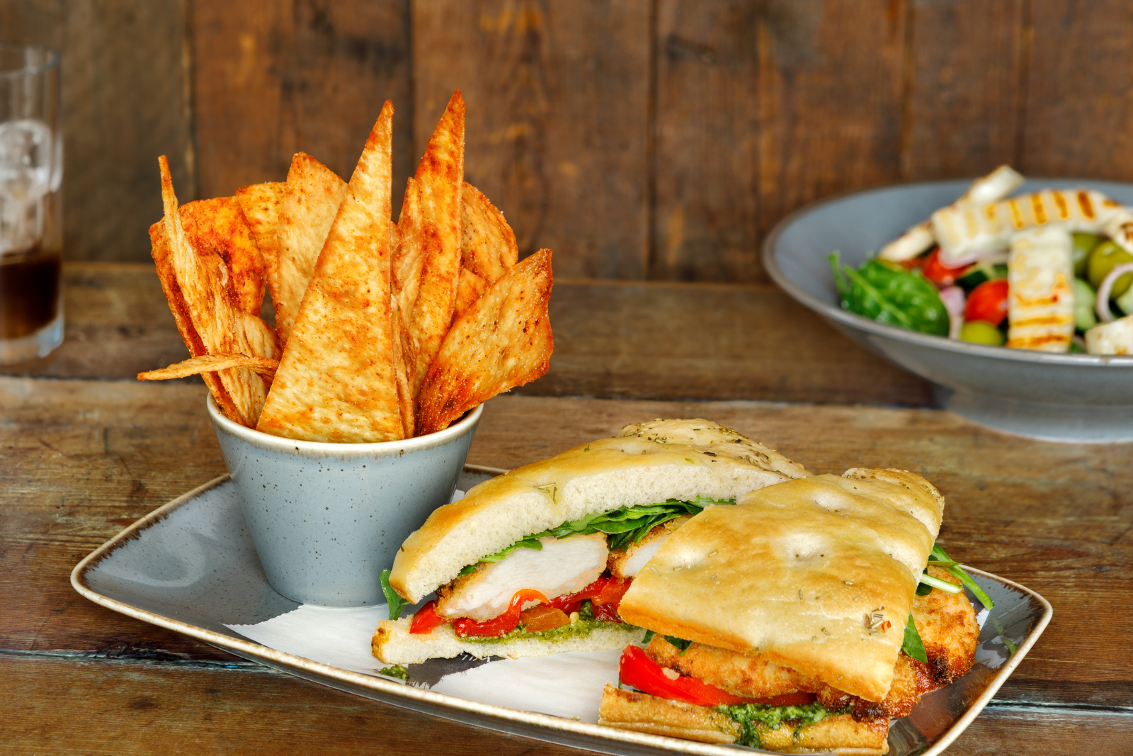 Rustic sandwich with chicken, red peppers, and rocket with tortilla chips