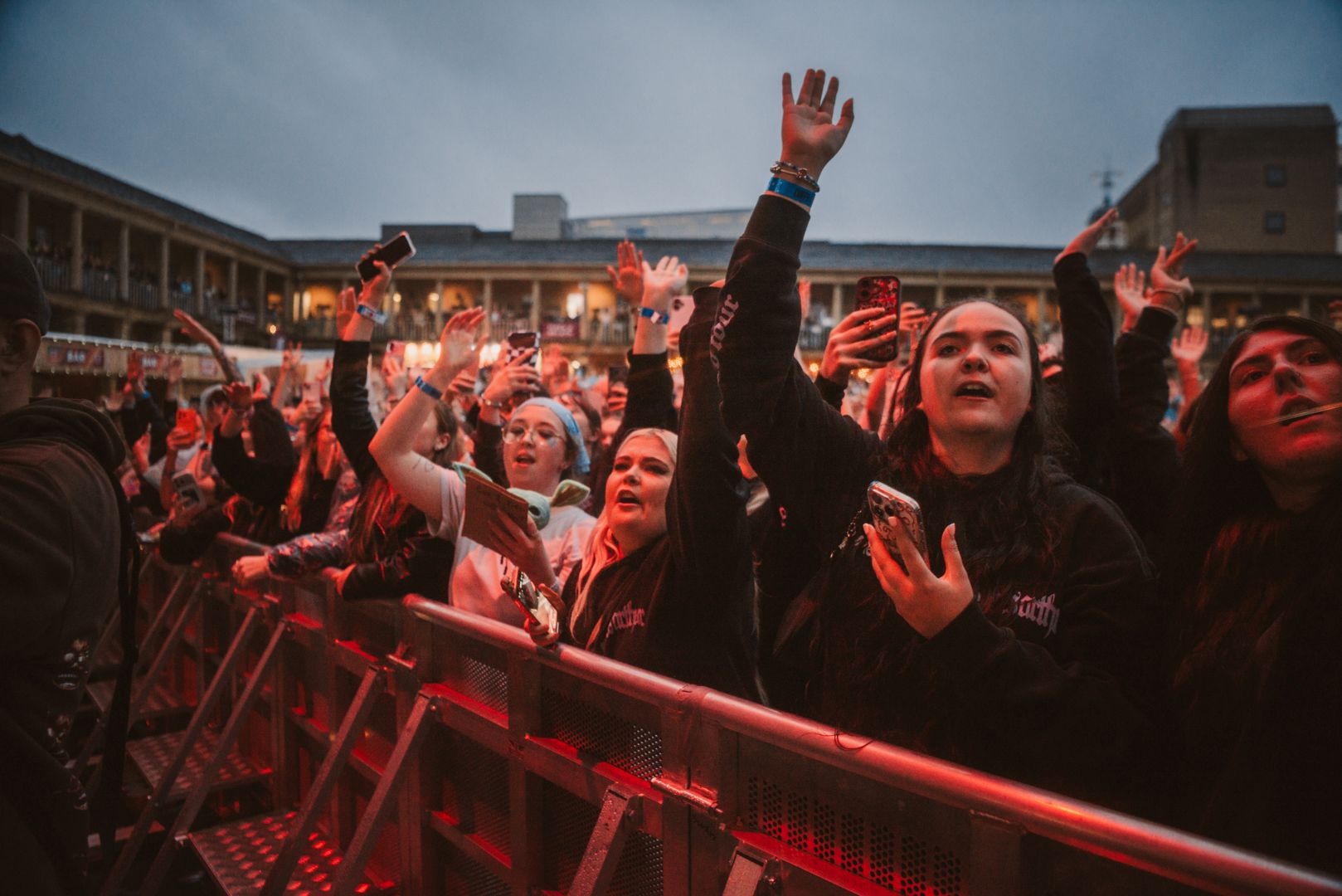 Crowd enjoying a lively outdoor concert at dusk