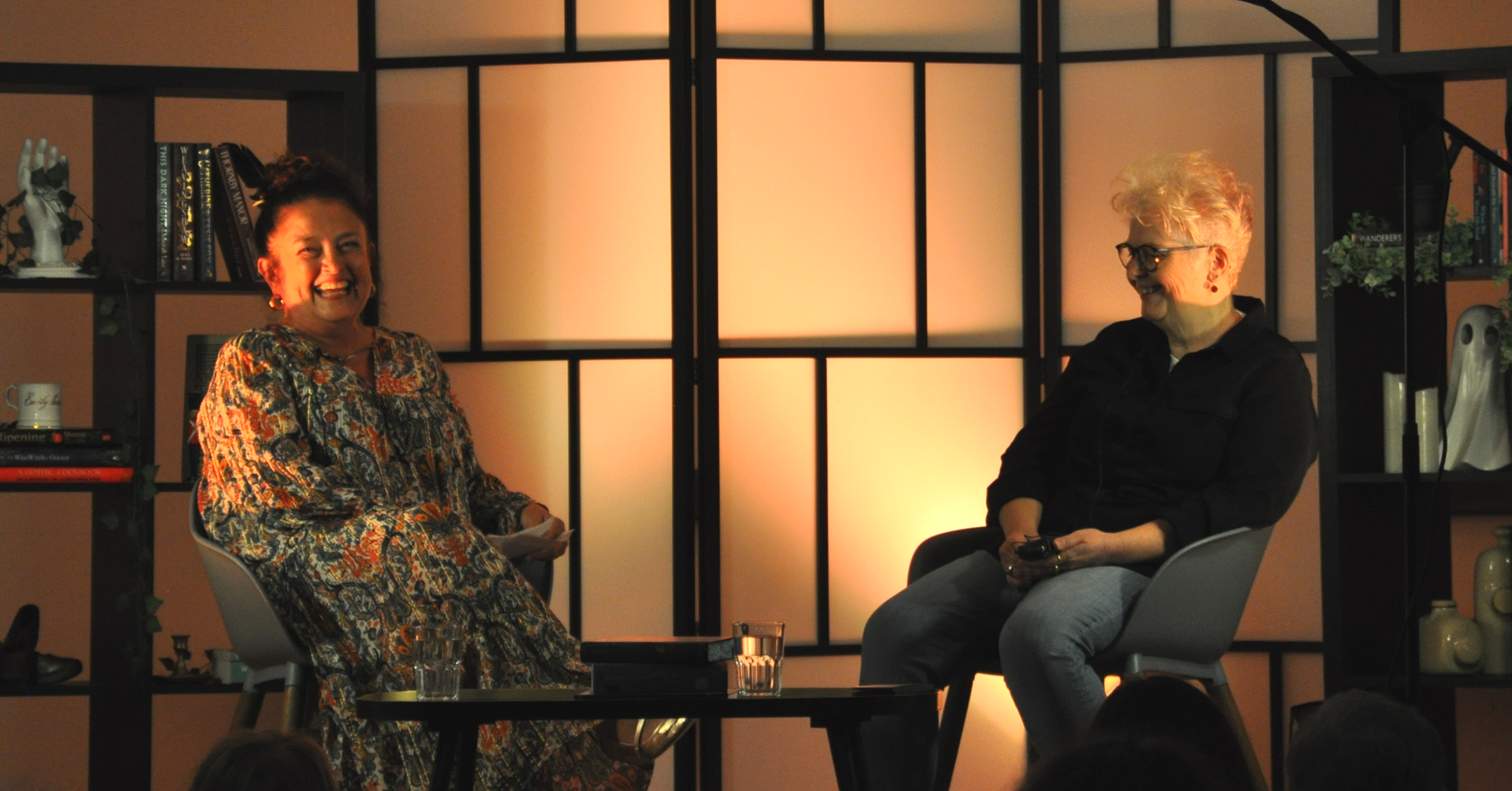 Two women seated on stage during a conversation event