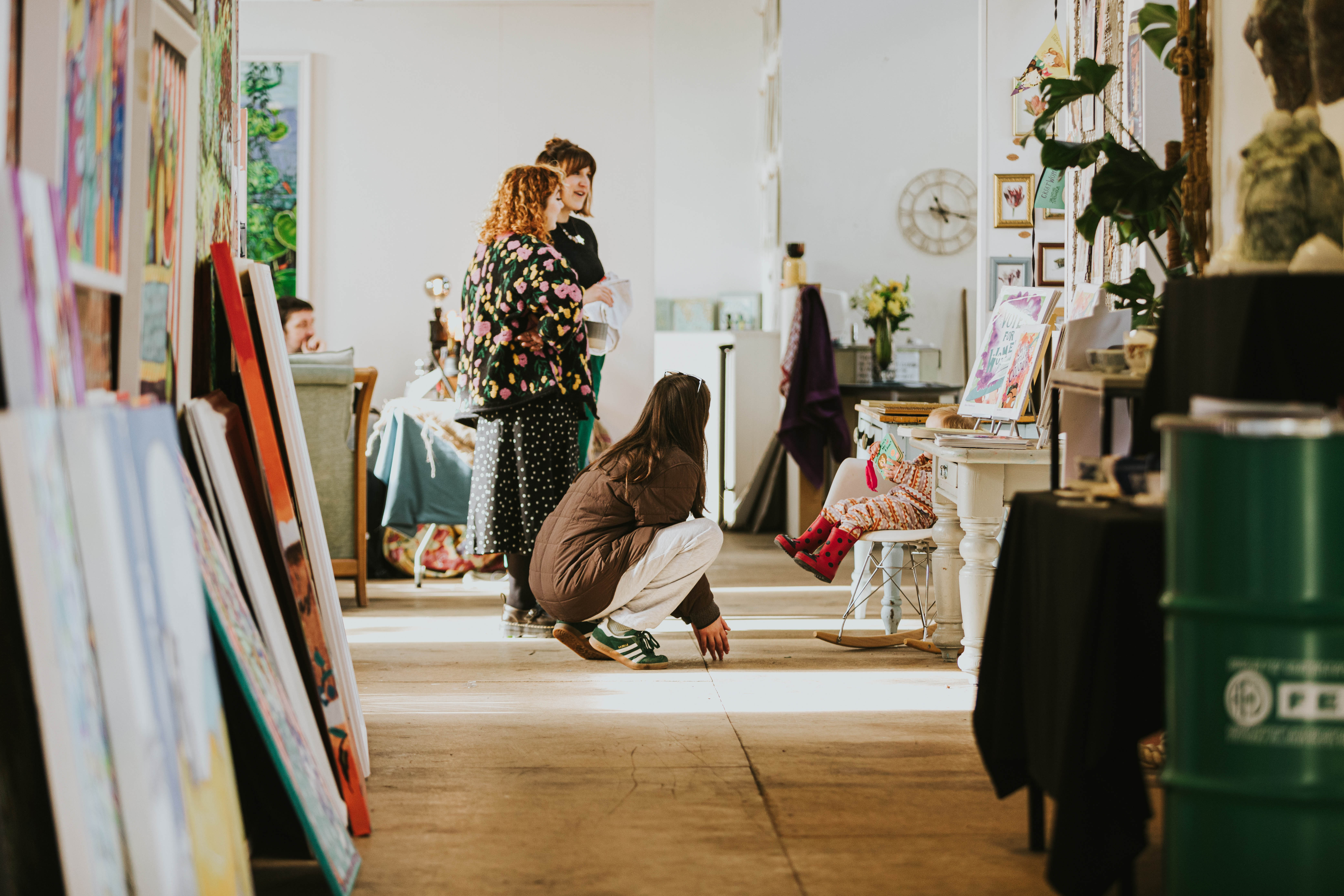Art gallery with visitors viewing paintings and sculptures