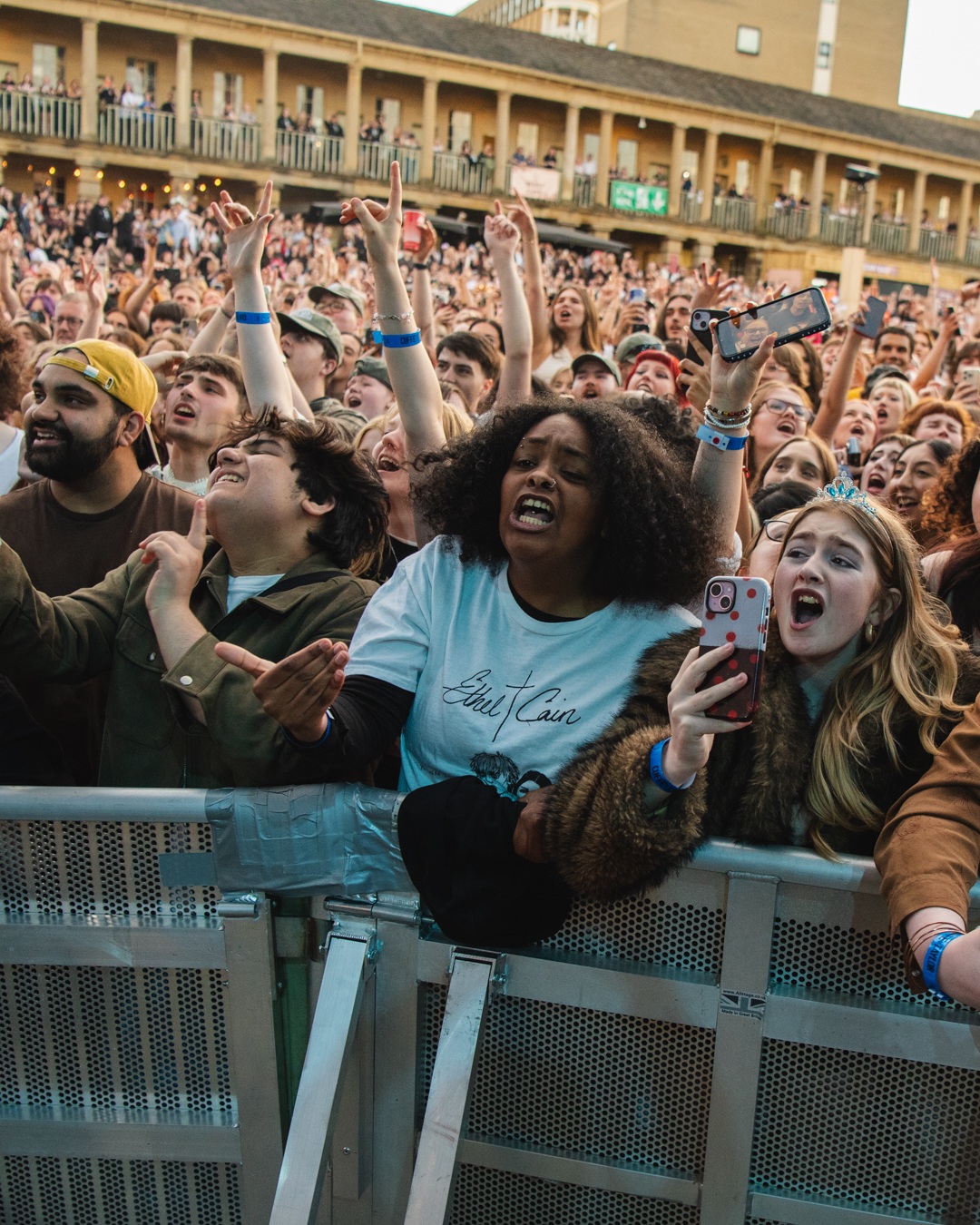 Excited crowd at an outdoor concert in Halifax courtyard