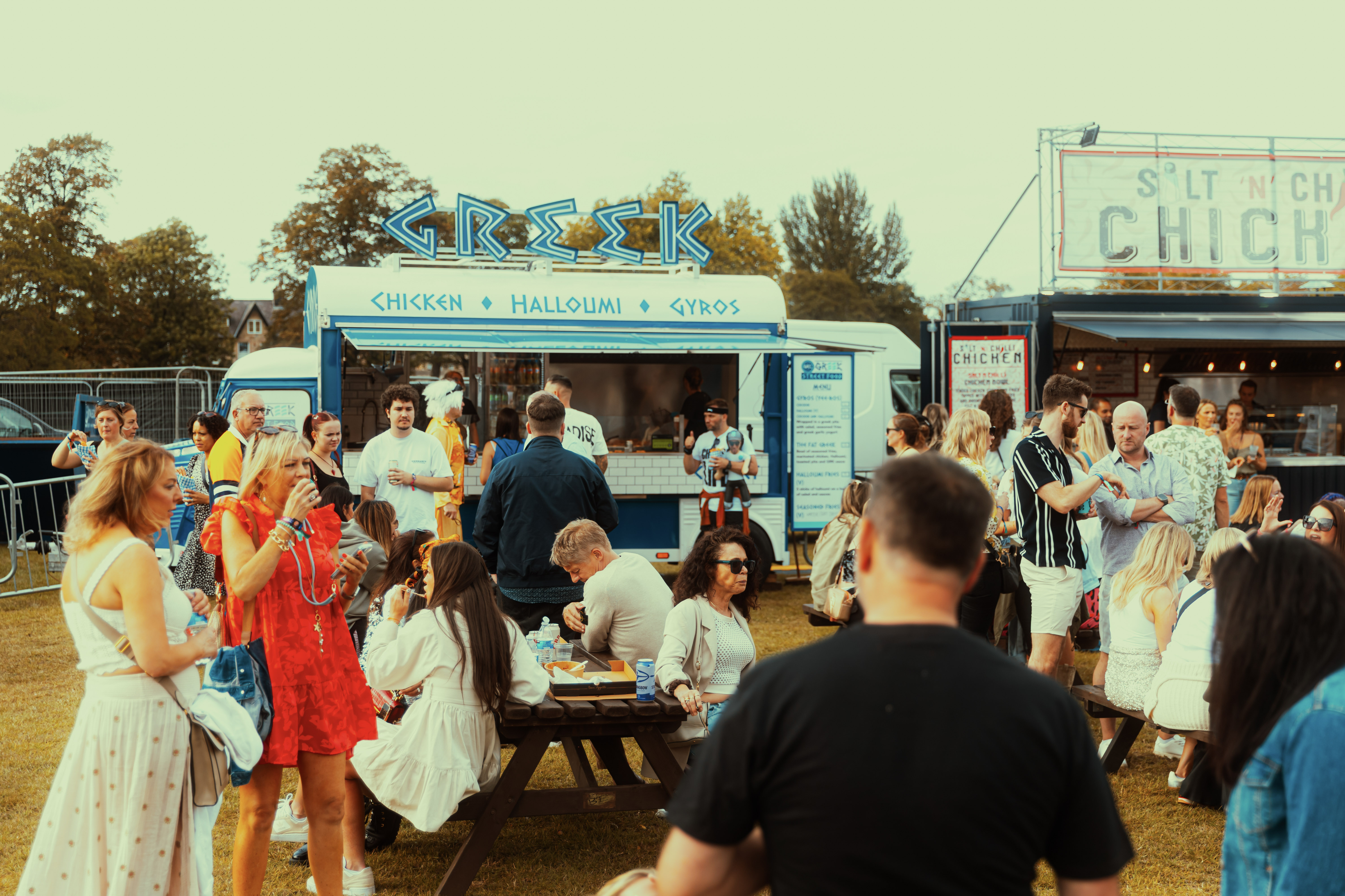 Crowd enjoying food at Greek street food truck in park