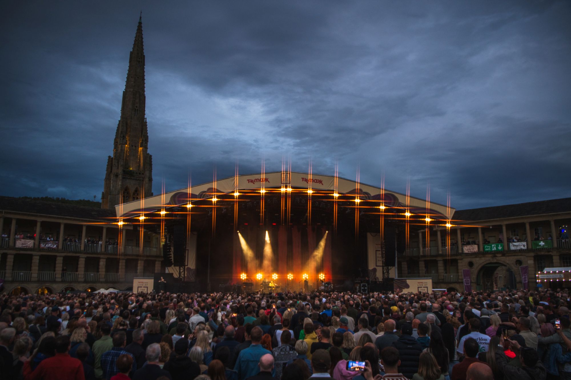 Evening concert at Halifax Piece Hall with lit stage and crowd