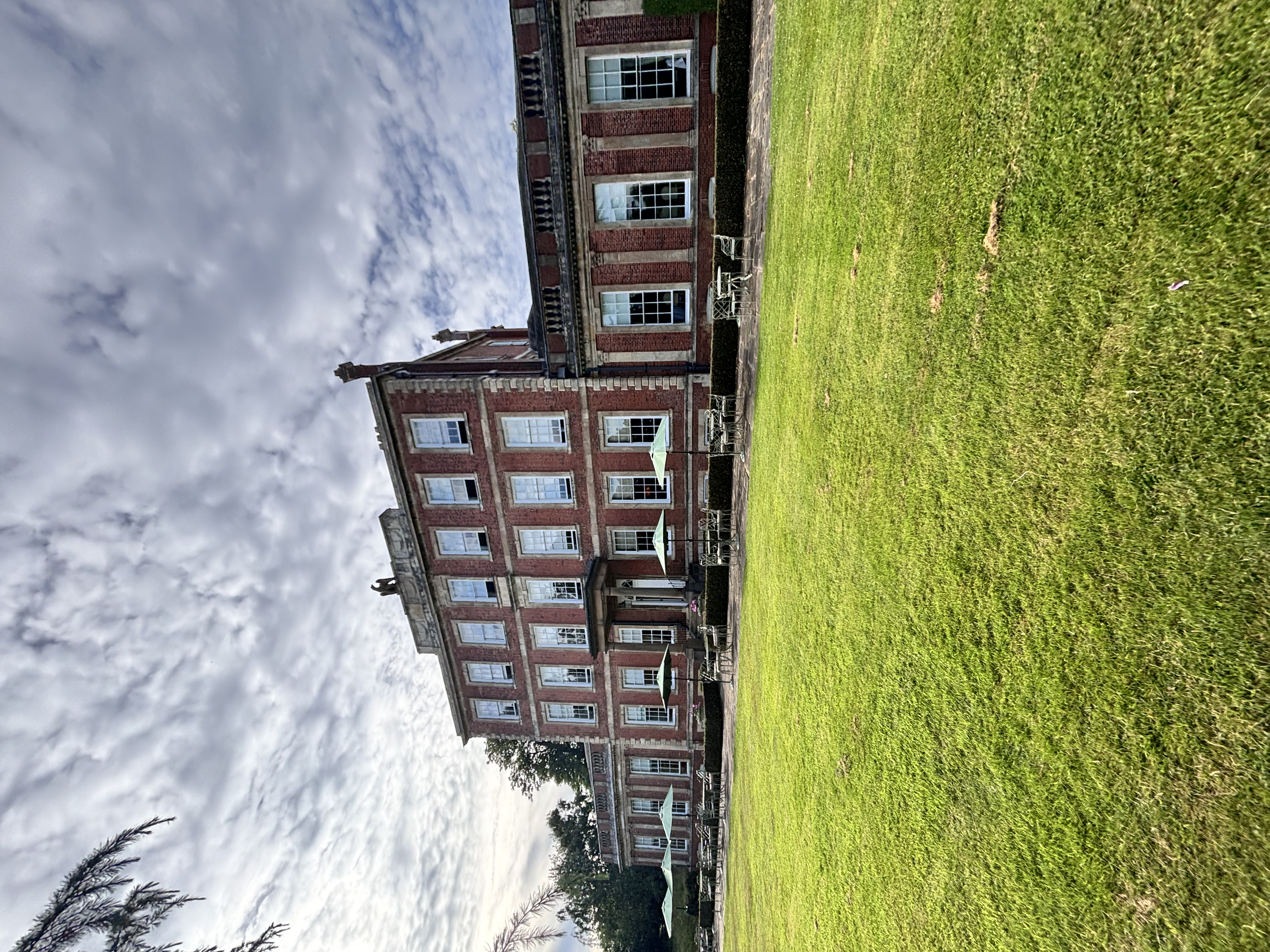 Elegant Georgian manor with red brick facade and lush lawn