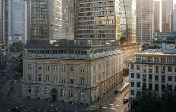 Modern skyscrapers surrounding historic stone building