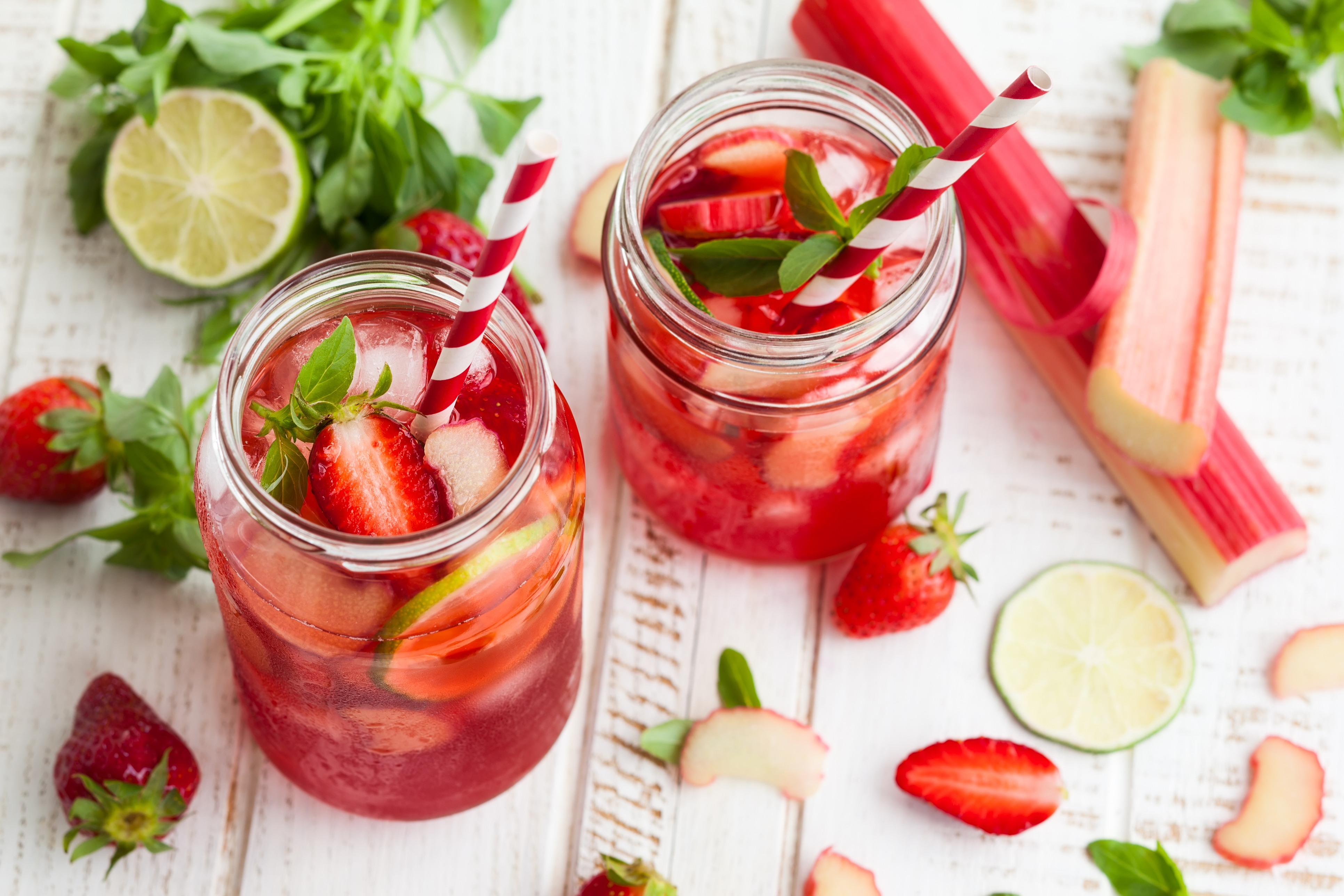 Refreshing strawberry and rhubarb drinks in glass jars