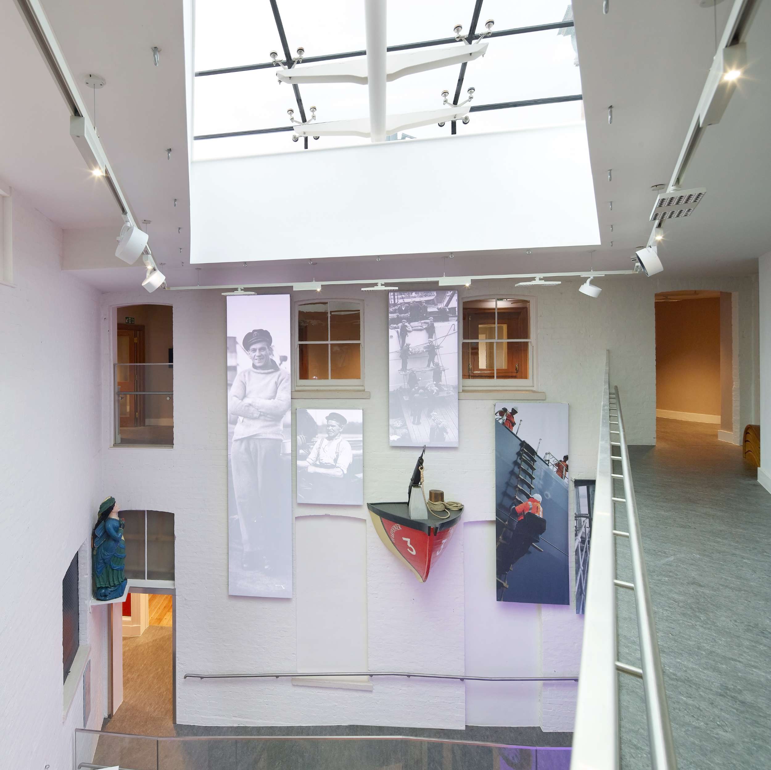 Modern museum interior with skylight and large photo displays