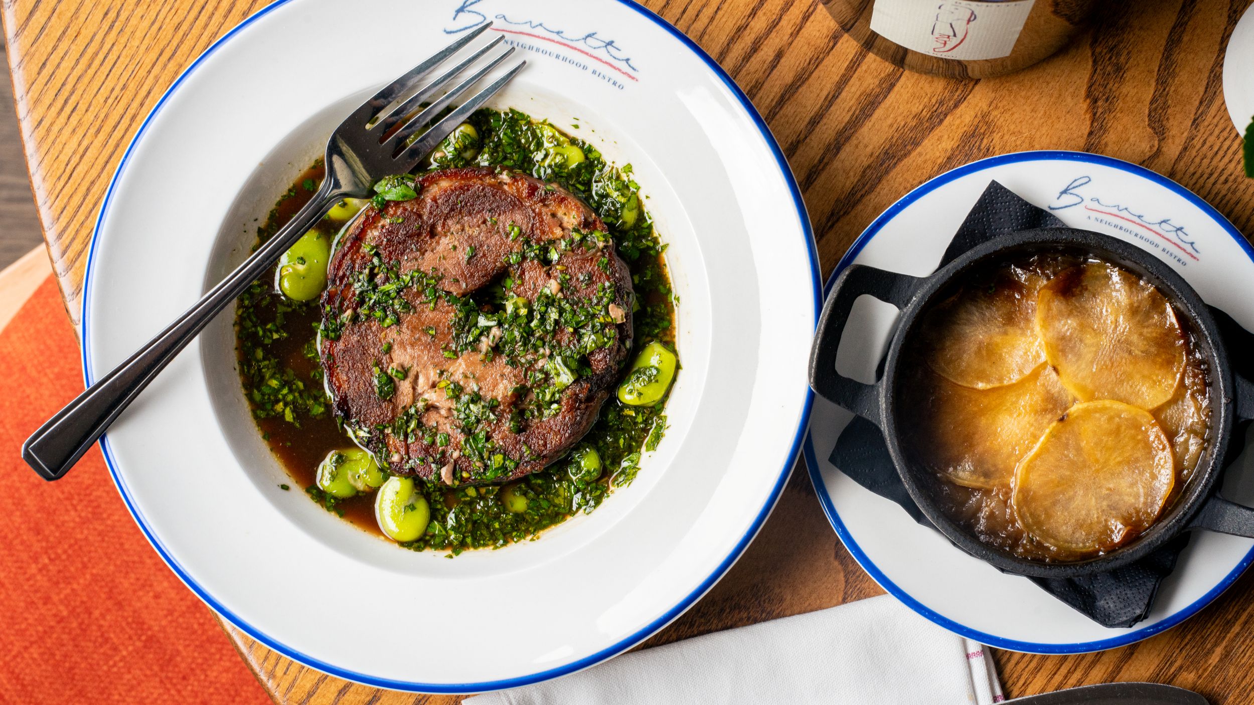 Gourmet beef dish with herbs and side of potato gratin