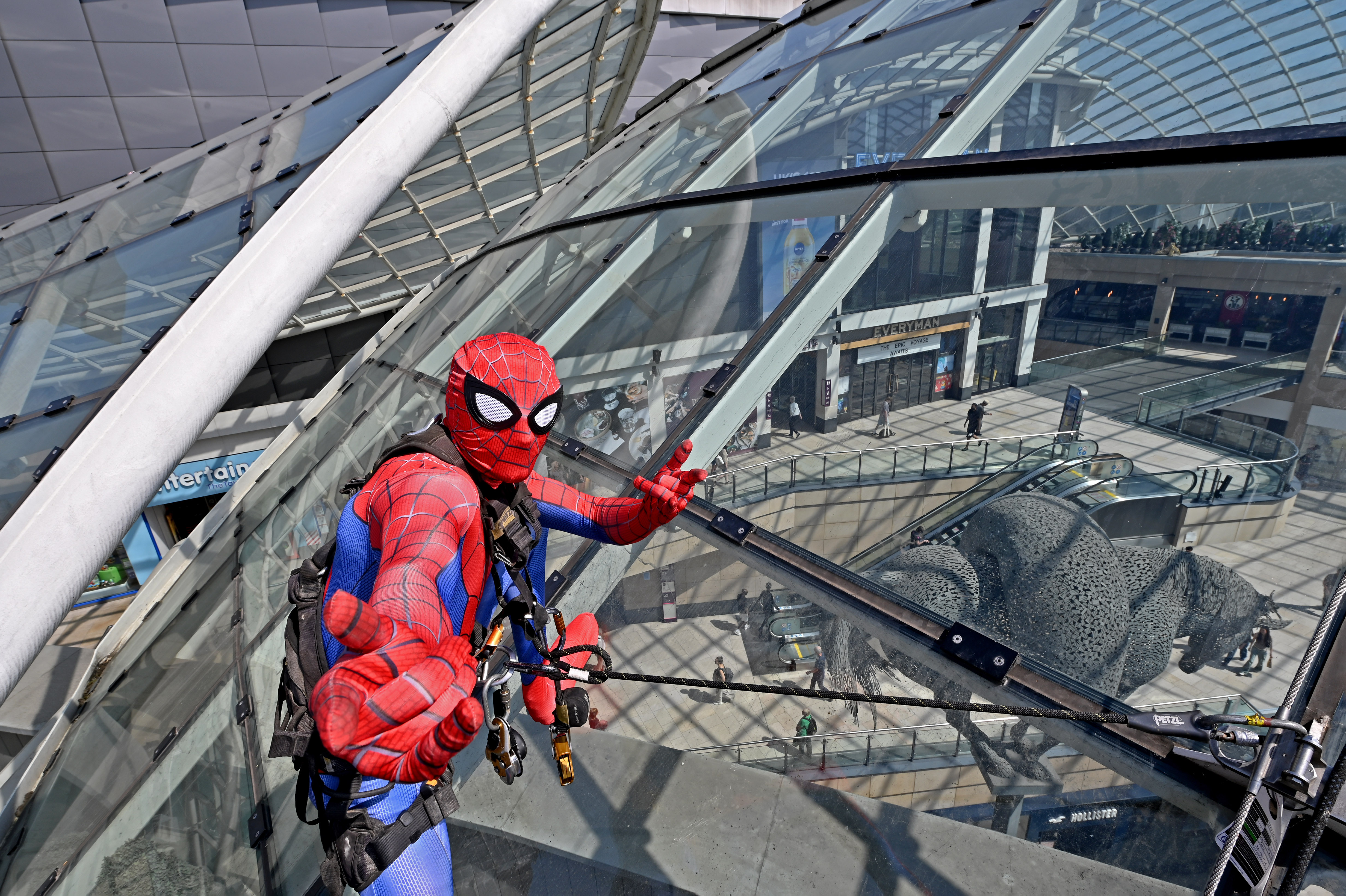 Spider-Man impersonator scaling glass roof at Leeds shopping centre