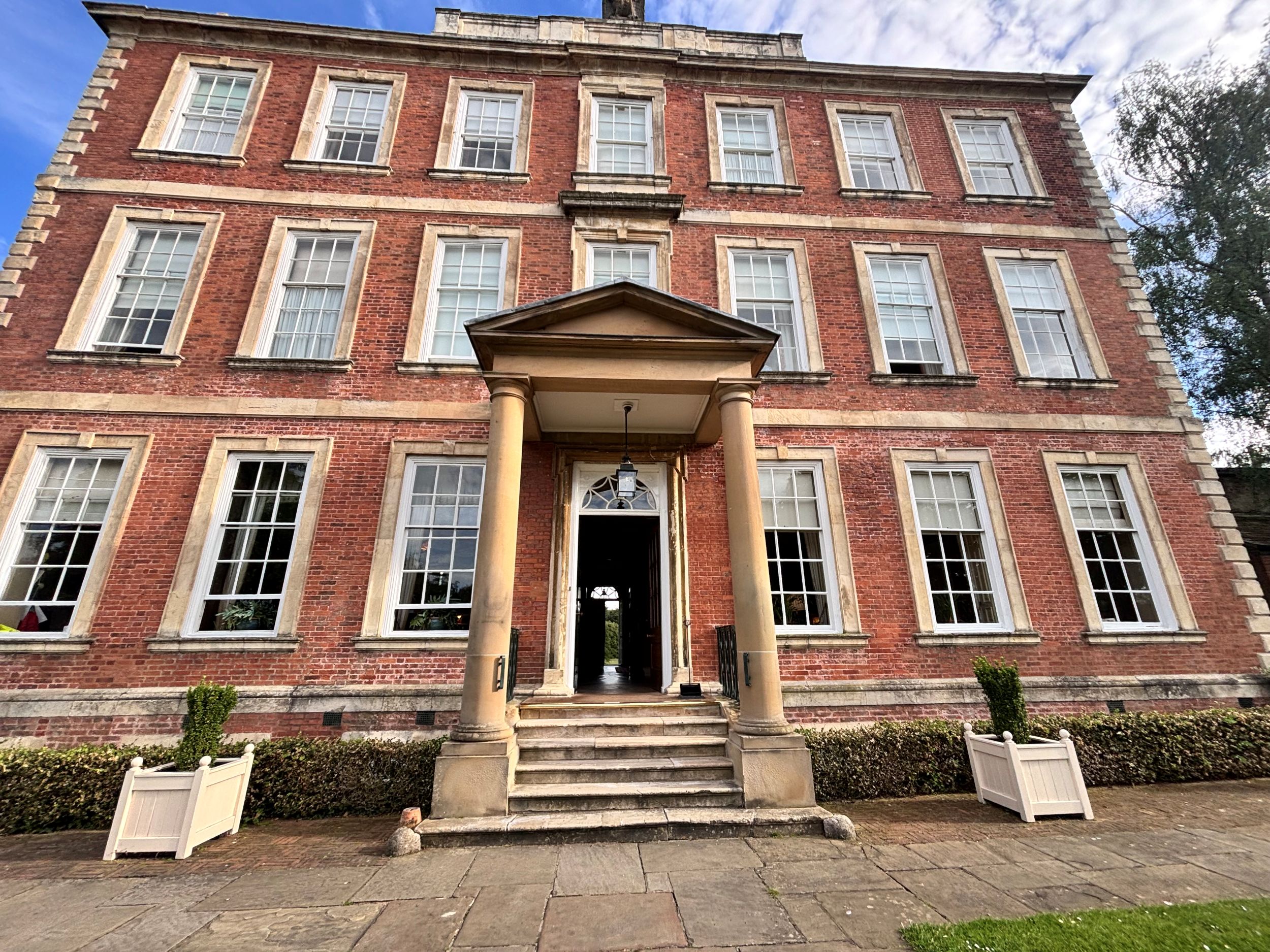 Georgian brick mansion with symmetrical windows and columns