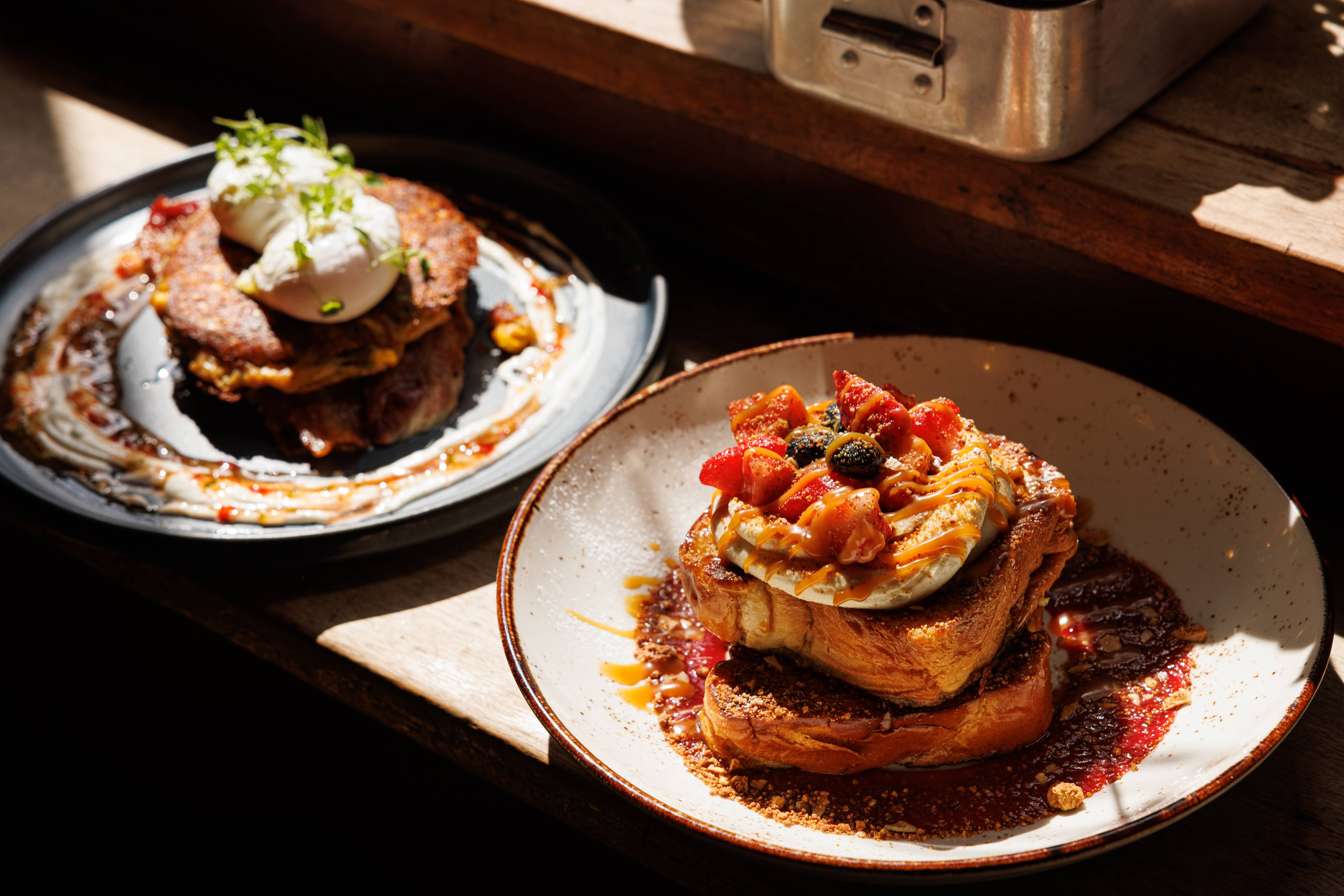 Rustic café breakfast with French toast and poached eggs in sunlight