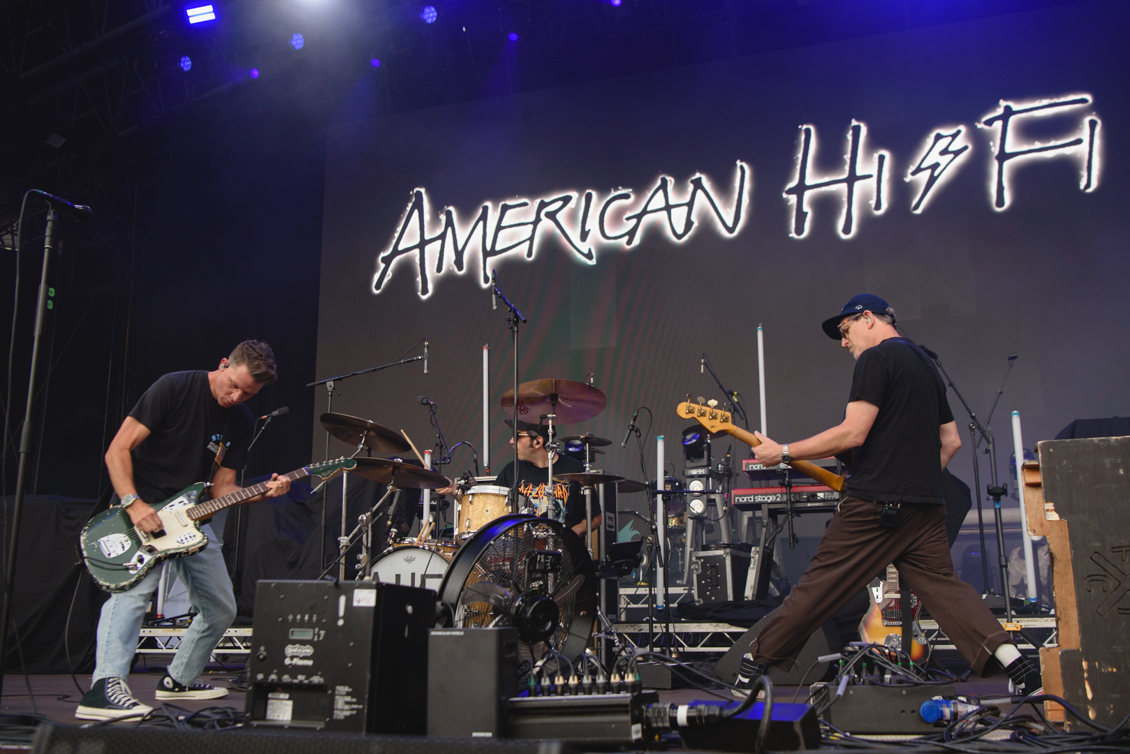 Band performing energetically on stage with instruments