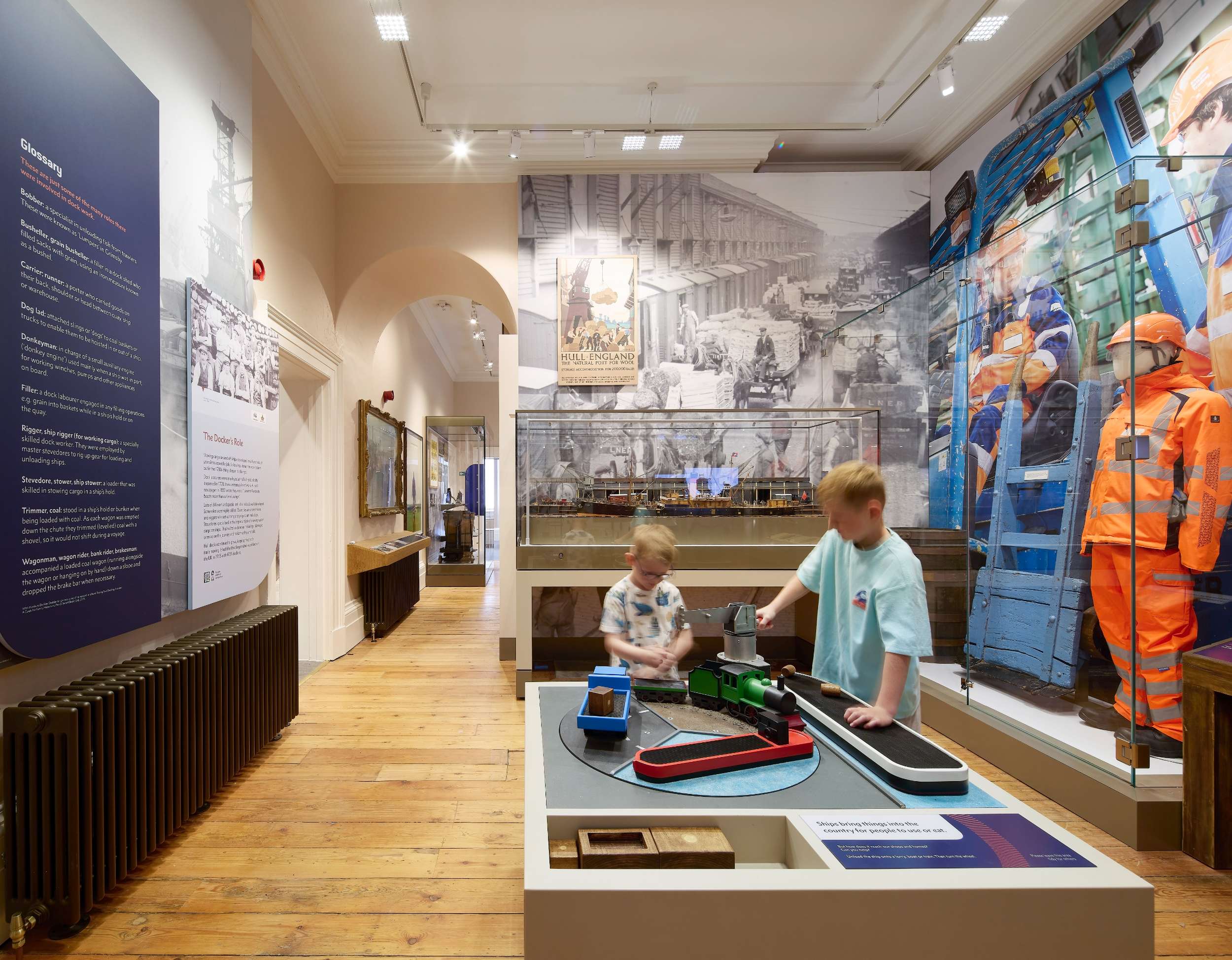 Children exploring a railway exhibit with historic photos and models