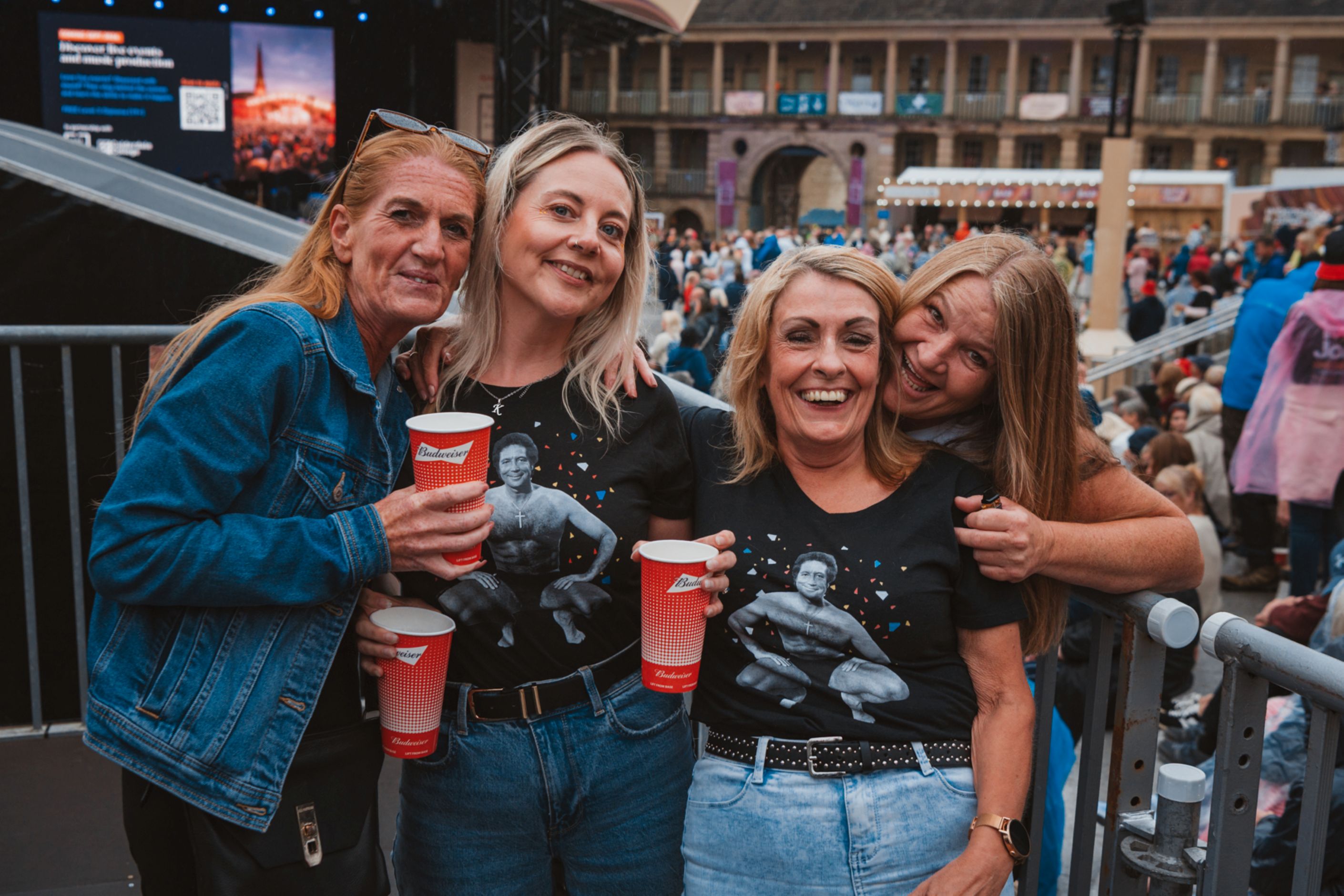 Four women smiling with drinks at an outdoor event in Halifax
