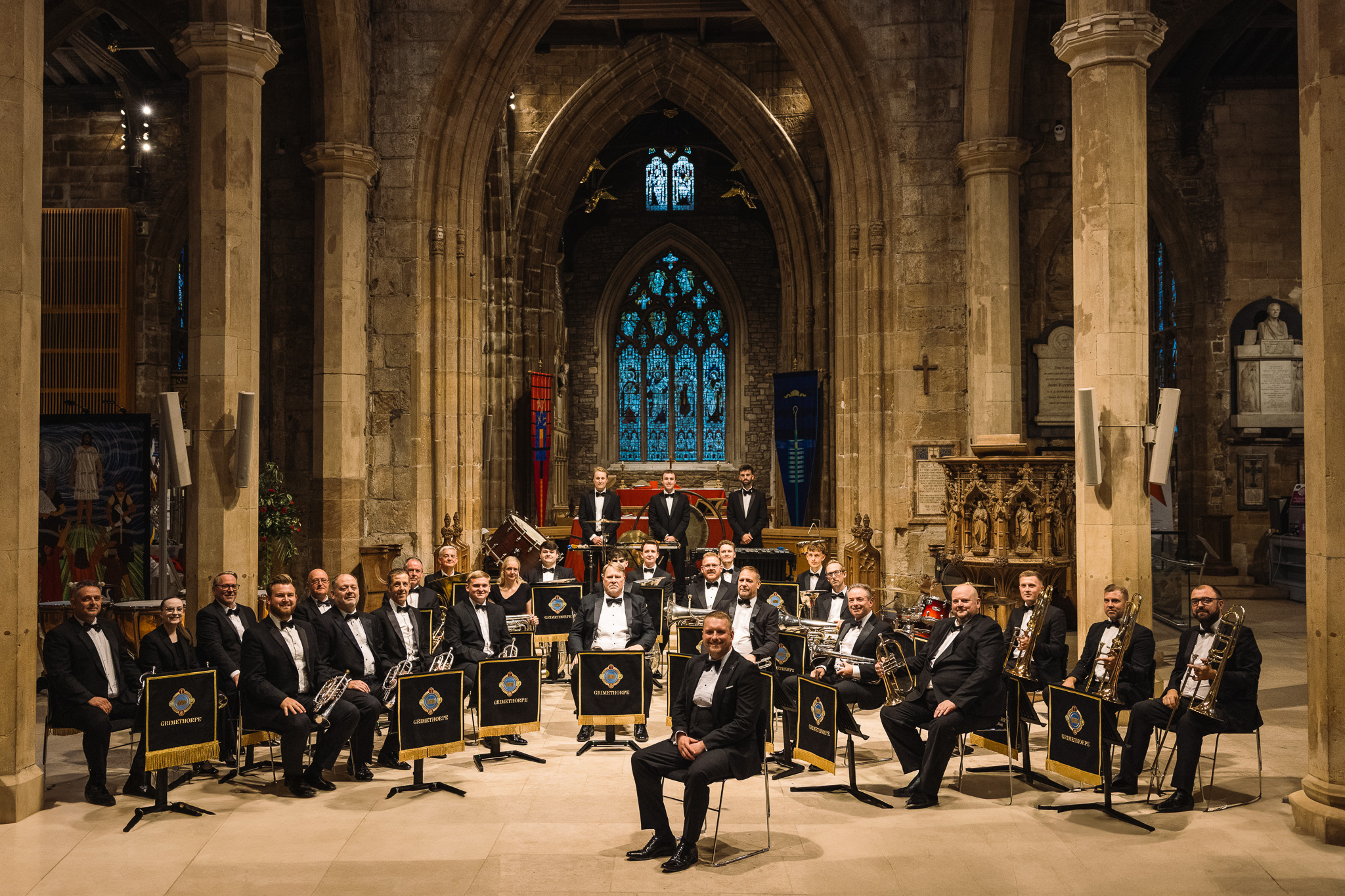 Orchestra in formal attire performing in historic church