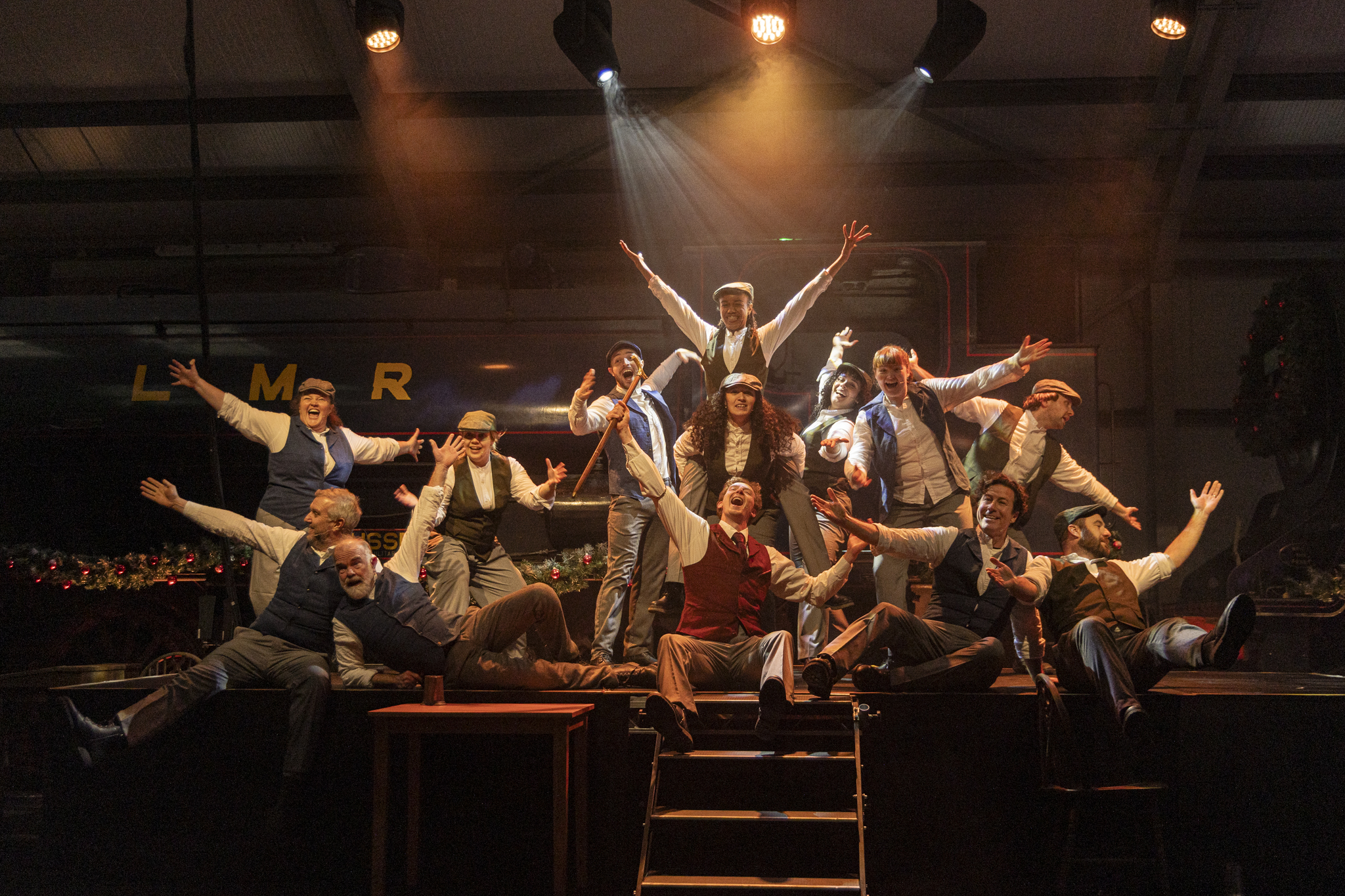 Performers in vintage attire posing energetically on stage