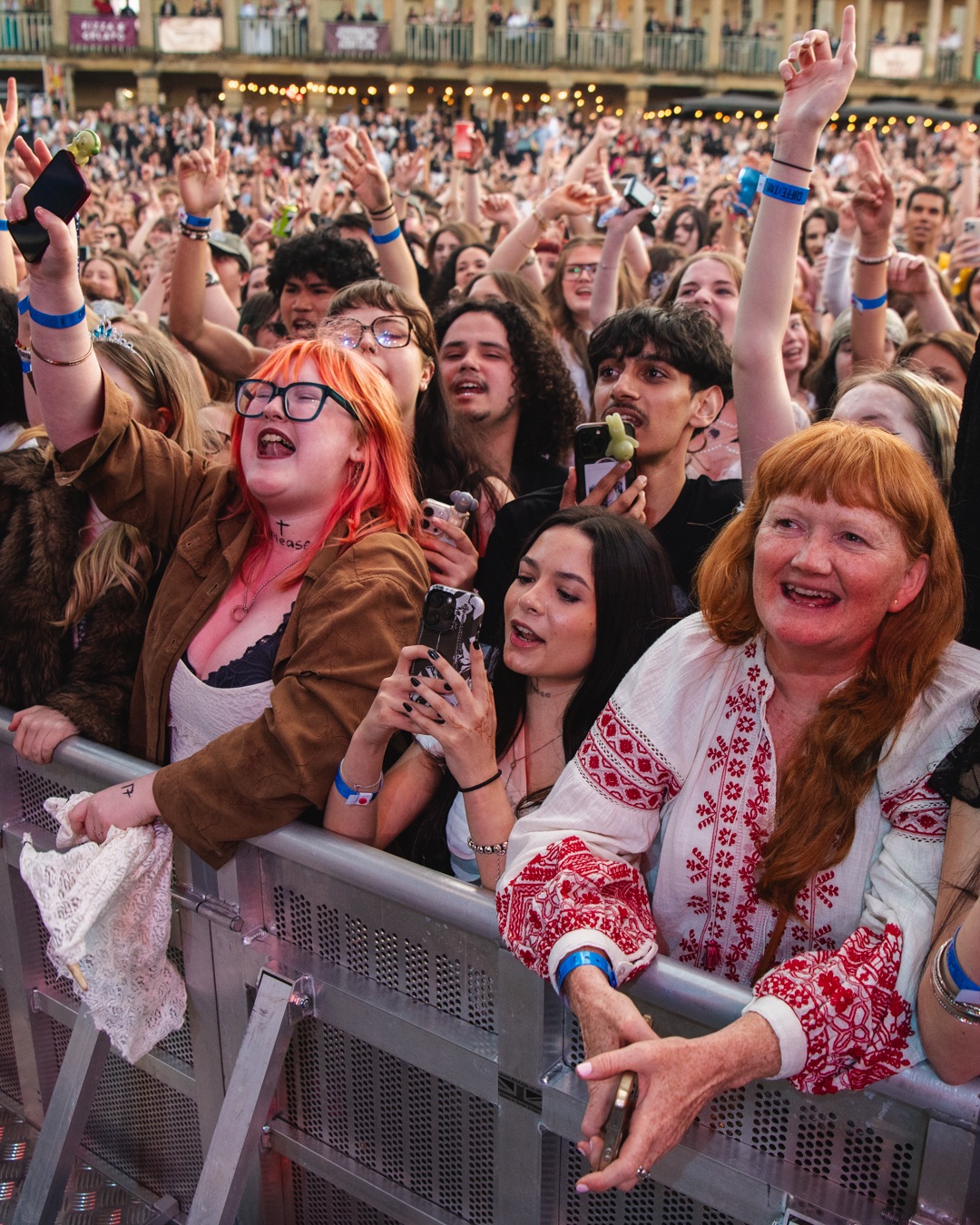 Crowd of enthusiastic festival-goers enjoying outdoor concert