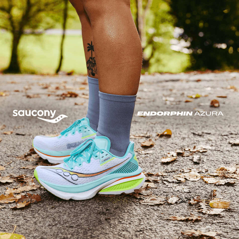 Runner wearing turquoise trainers on leafy path in autumn park