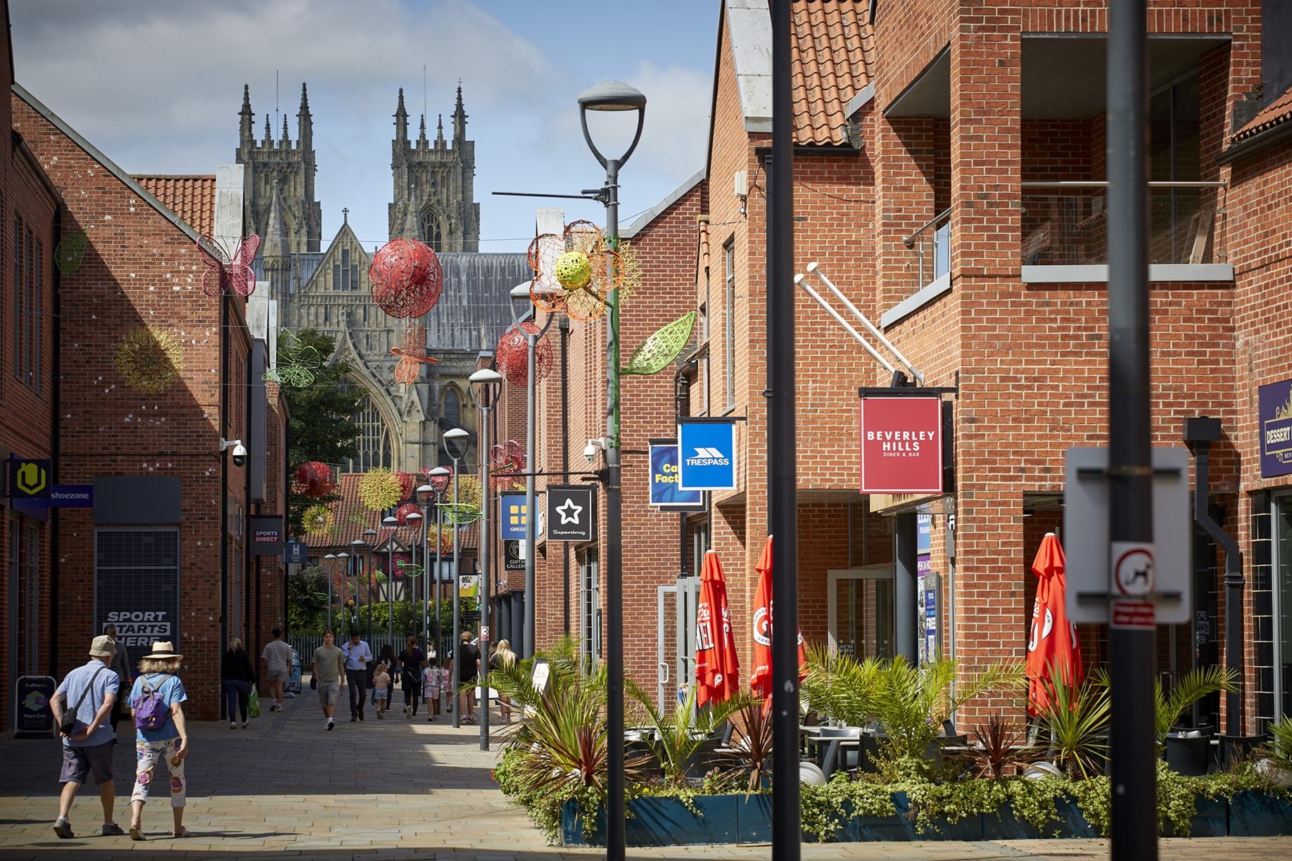 Pedestrian street with shops and York Minster in the background