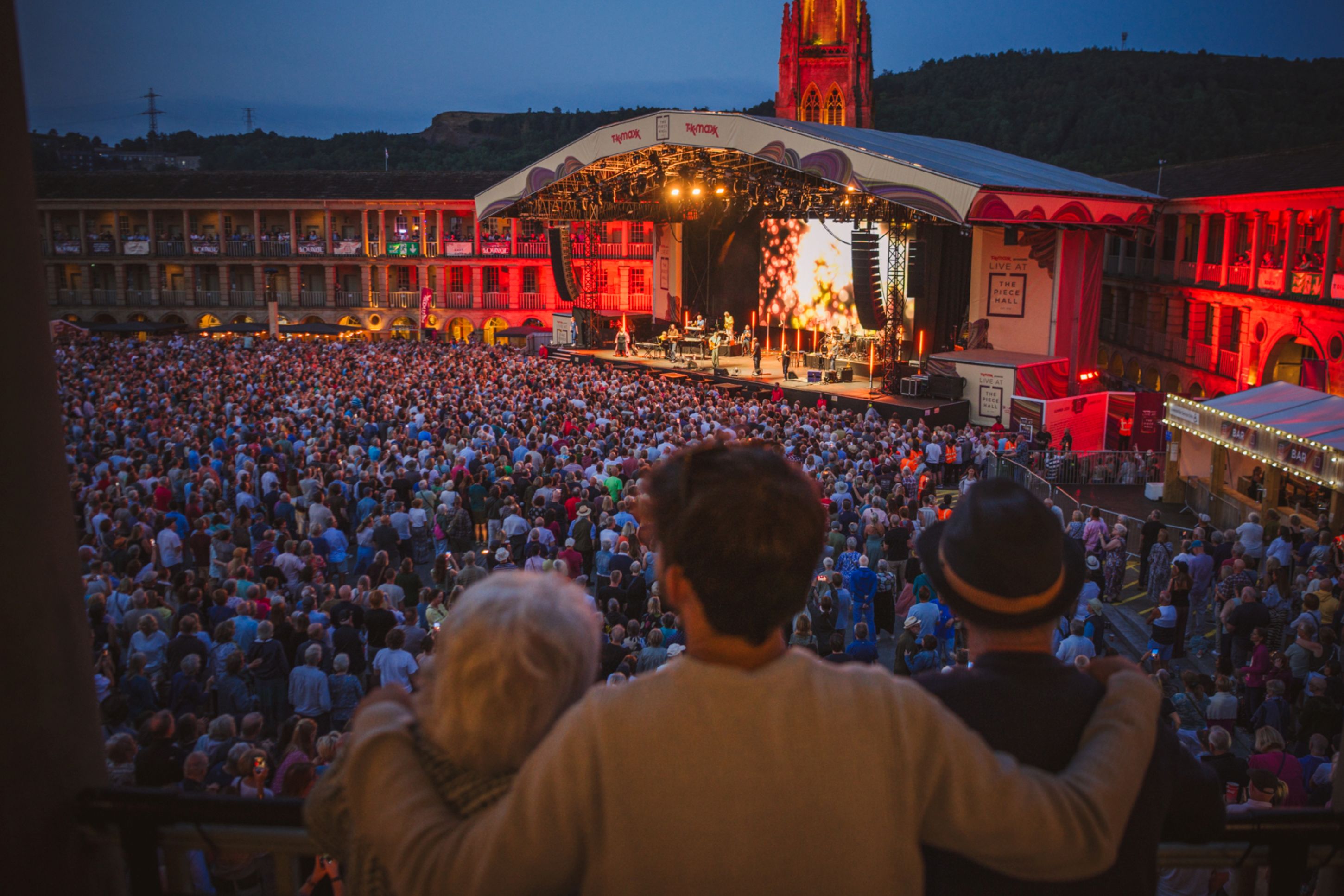 Crowd enjoying an outdoor evening concert at Piece Hall, Halifax
