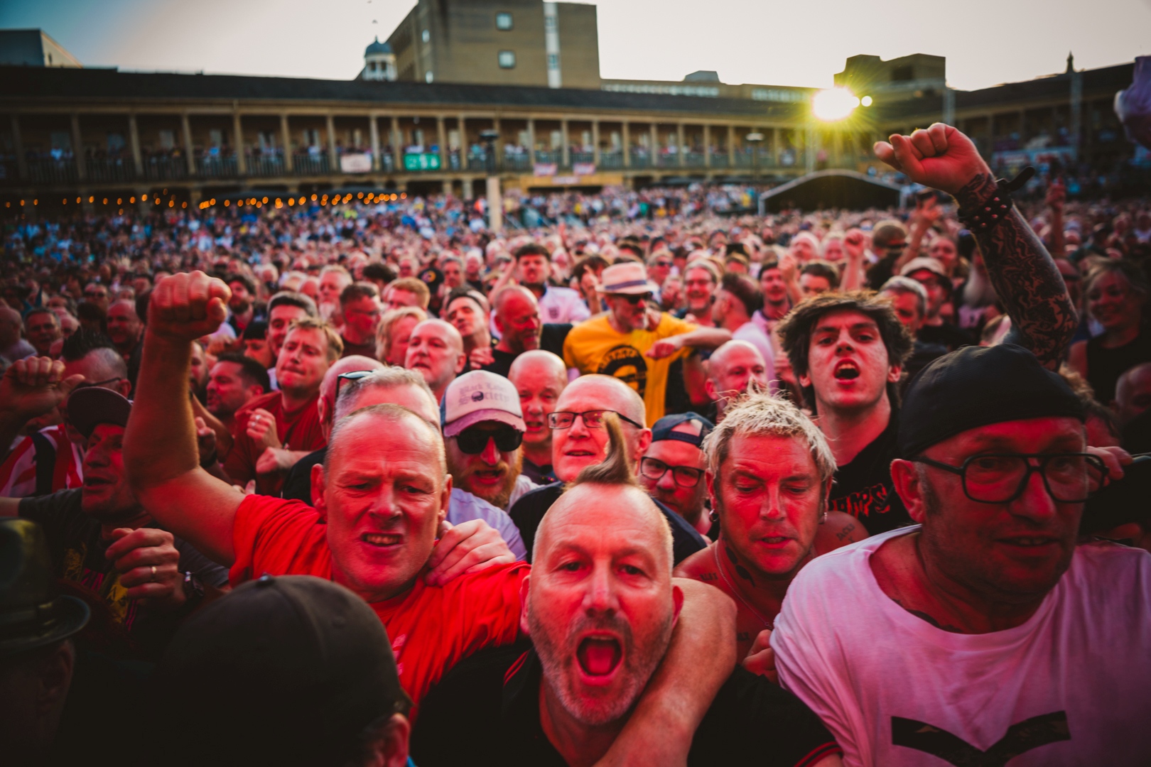 Excited crowd at lively outdoor concert in Halifax courtyard