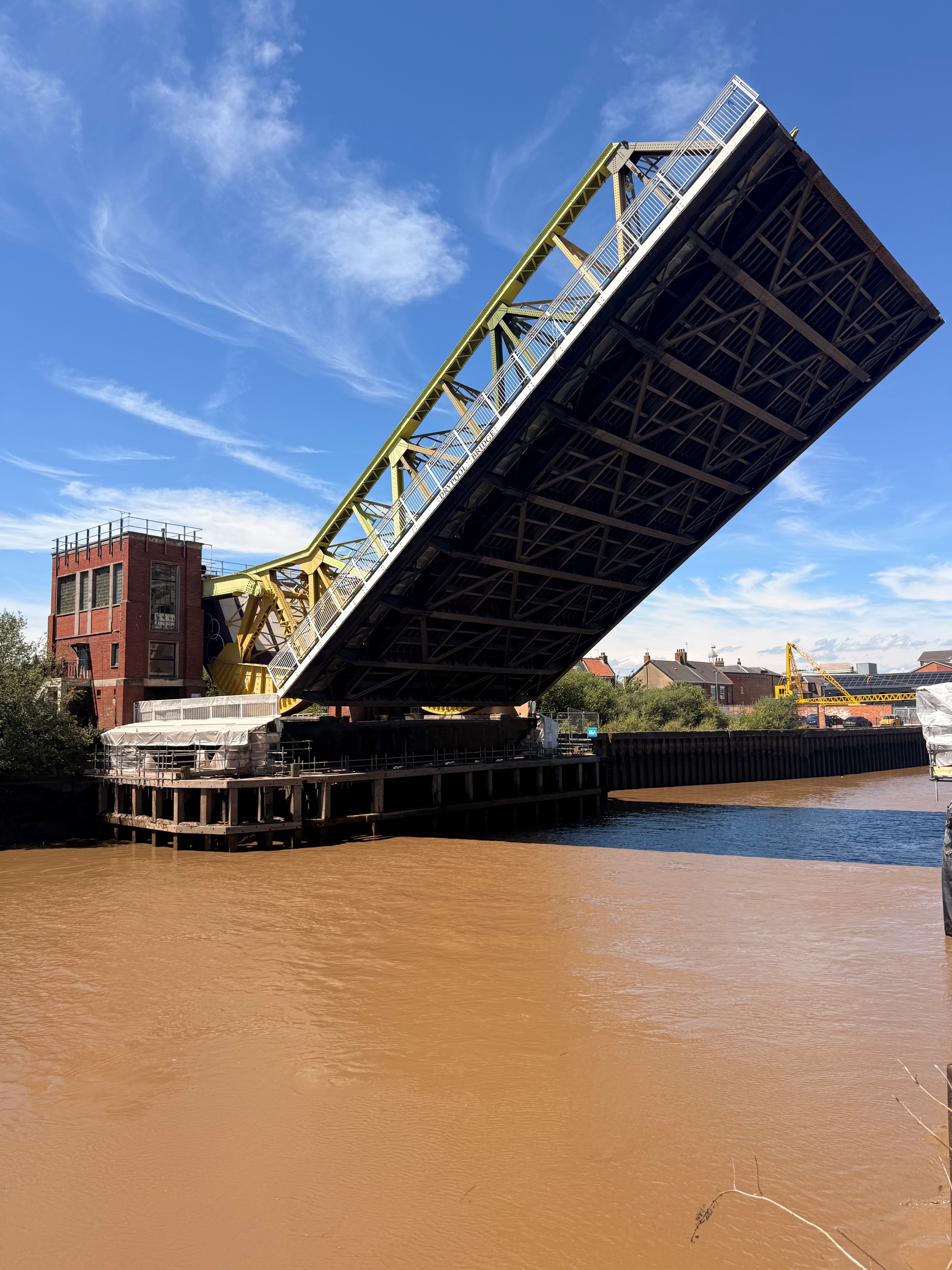 Raised drawbridge over River Hull with blue sky