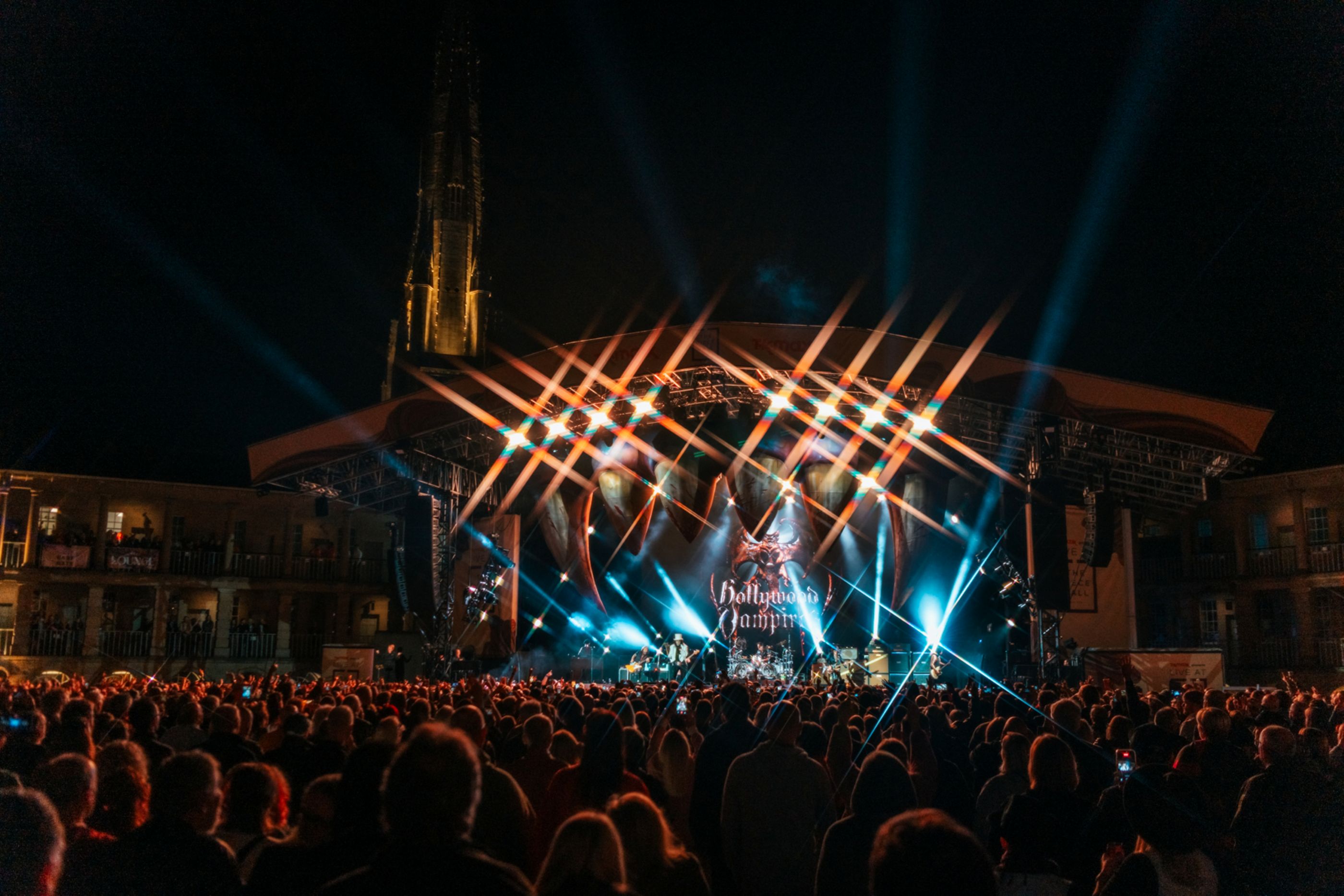 Crowd enjoying a night concert with vibrant stage lights in Yorkshire