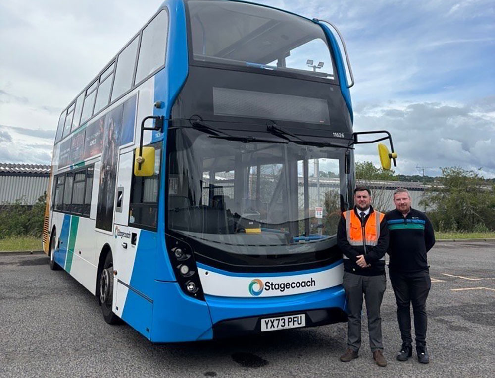 Double-decker bus with two men standing in front
