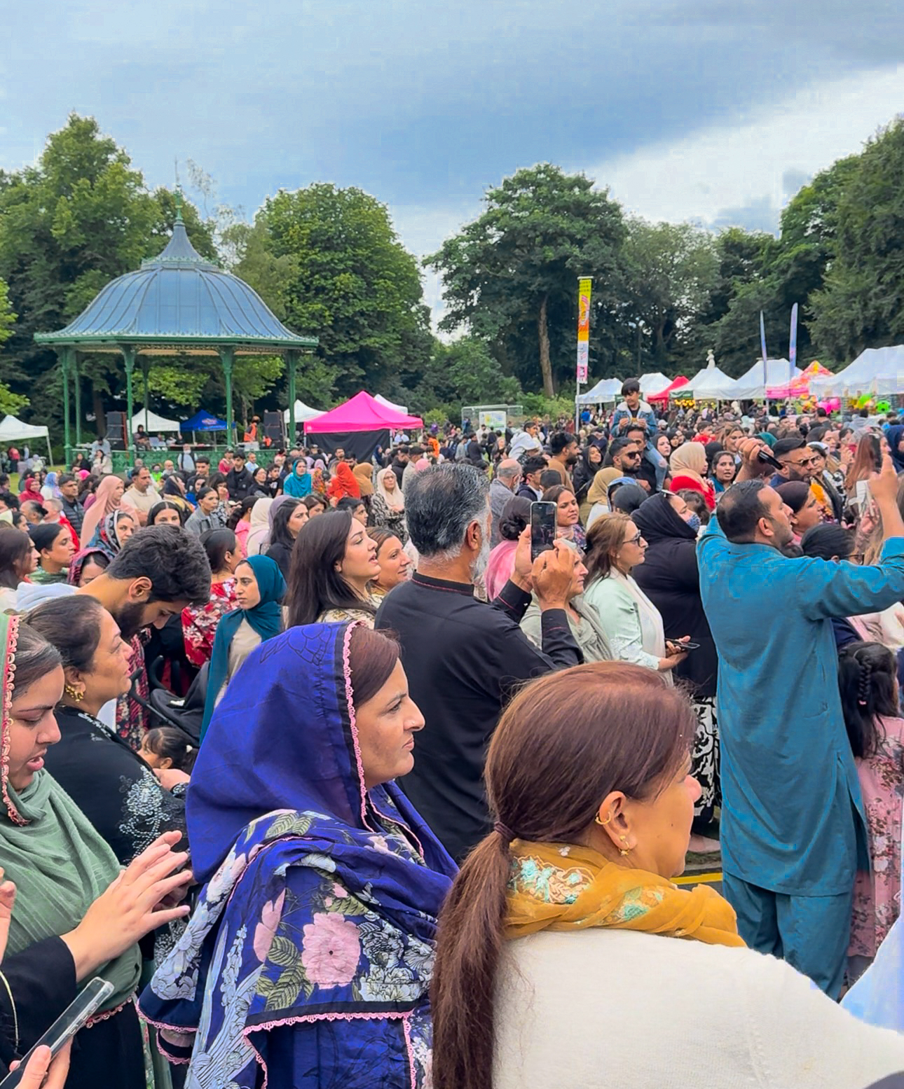CultureDale - Crowd at outdoor festival with people in colorful attire