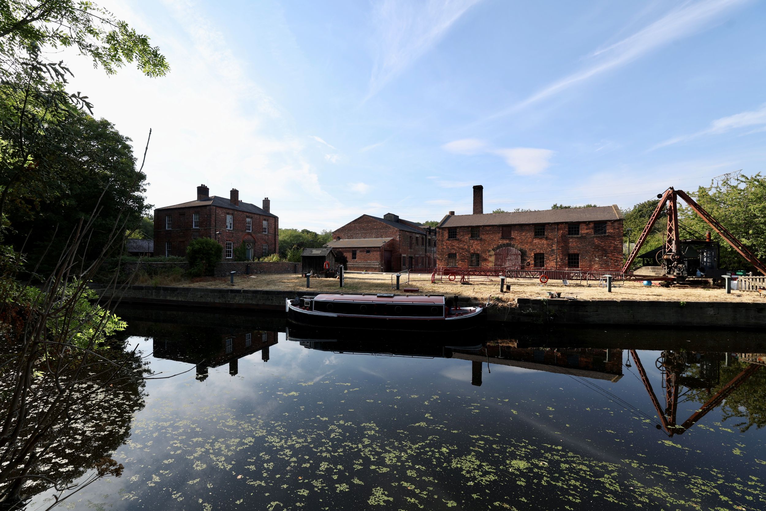 Historic red brick canal dockyard with moored narrowboat