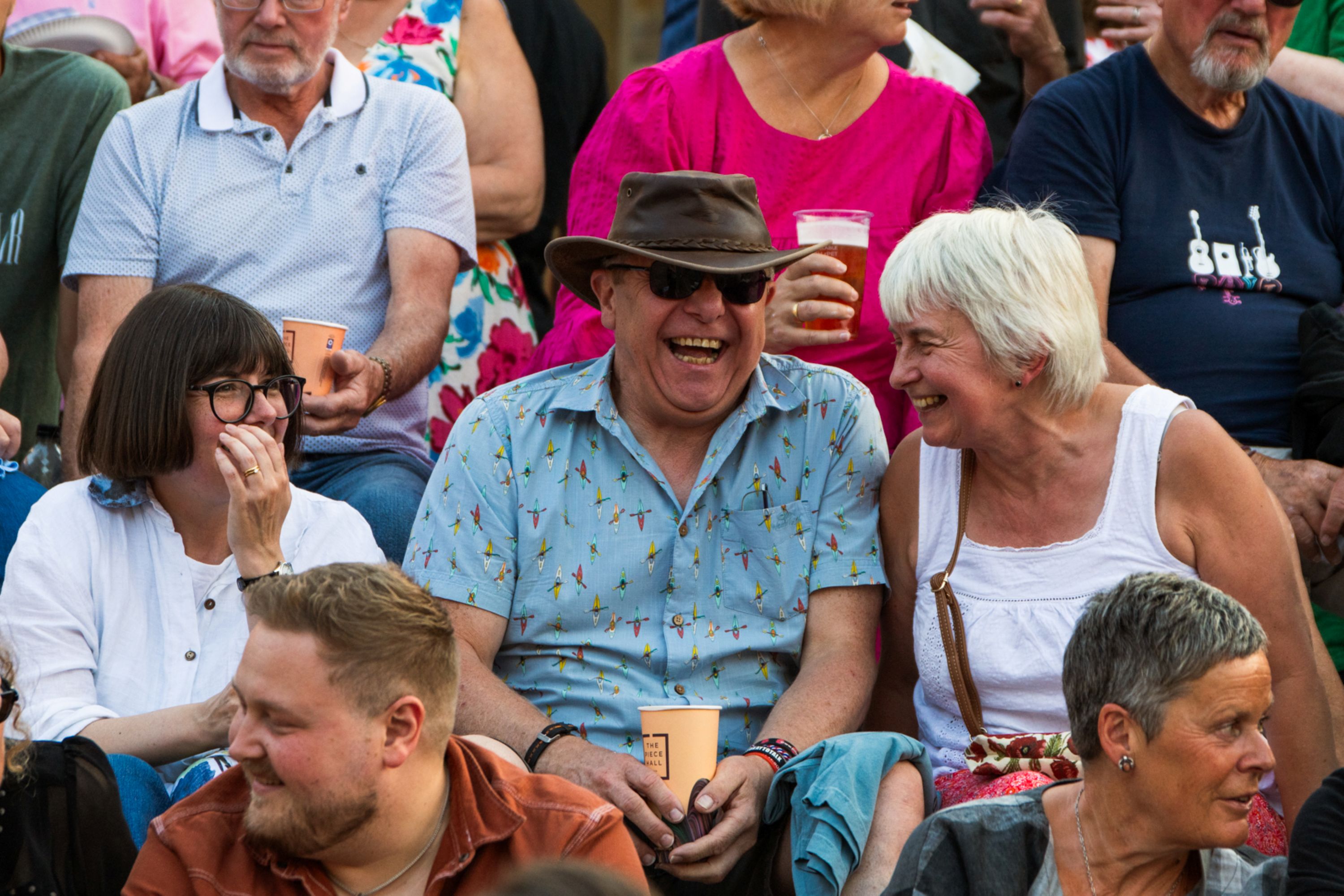 Cheerful crowd enjoying a sunny outdoor event in Yorkshire