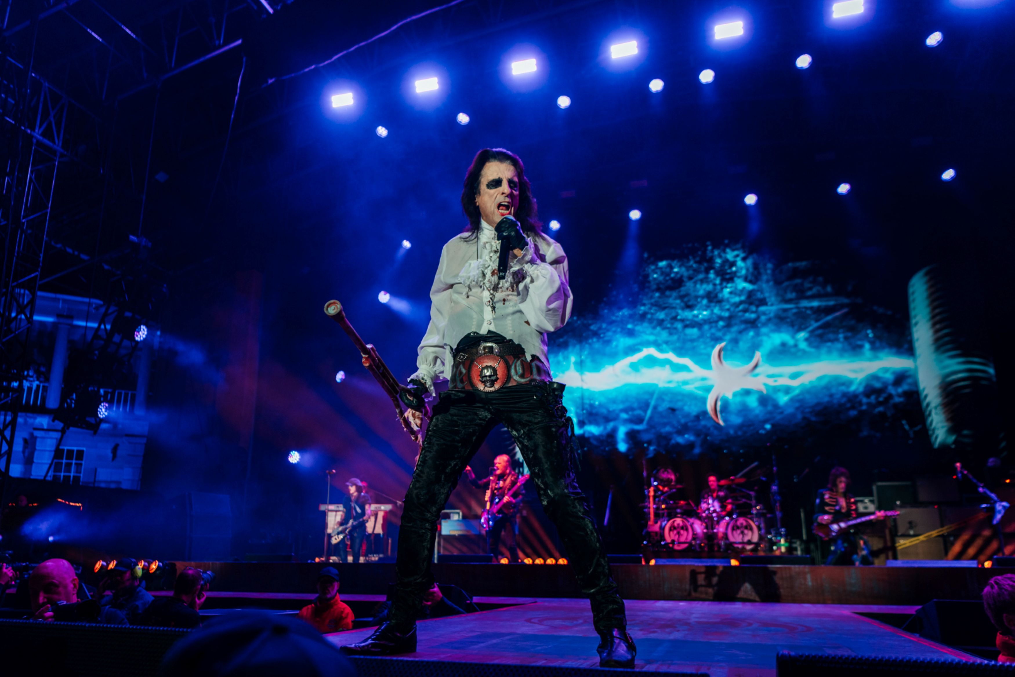 Rock musician performing on stage with electric blue lights