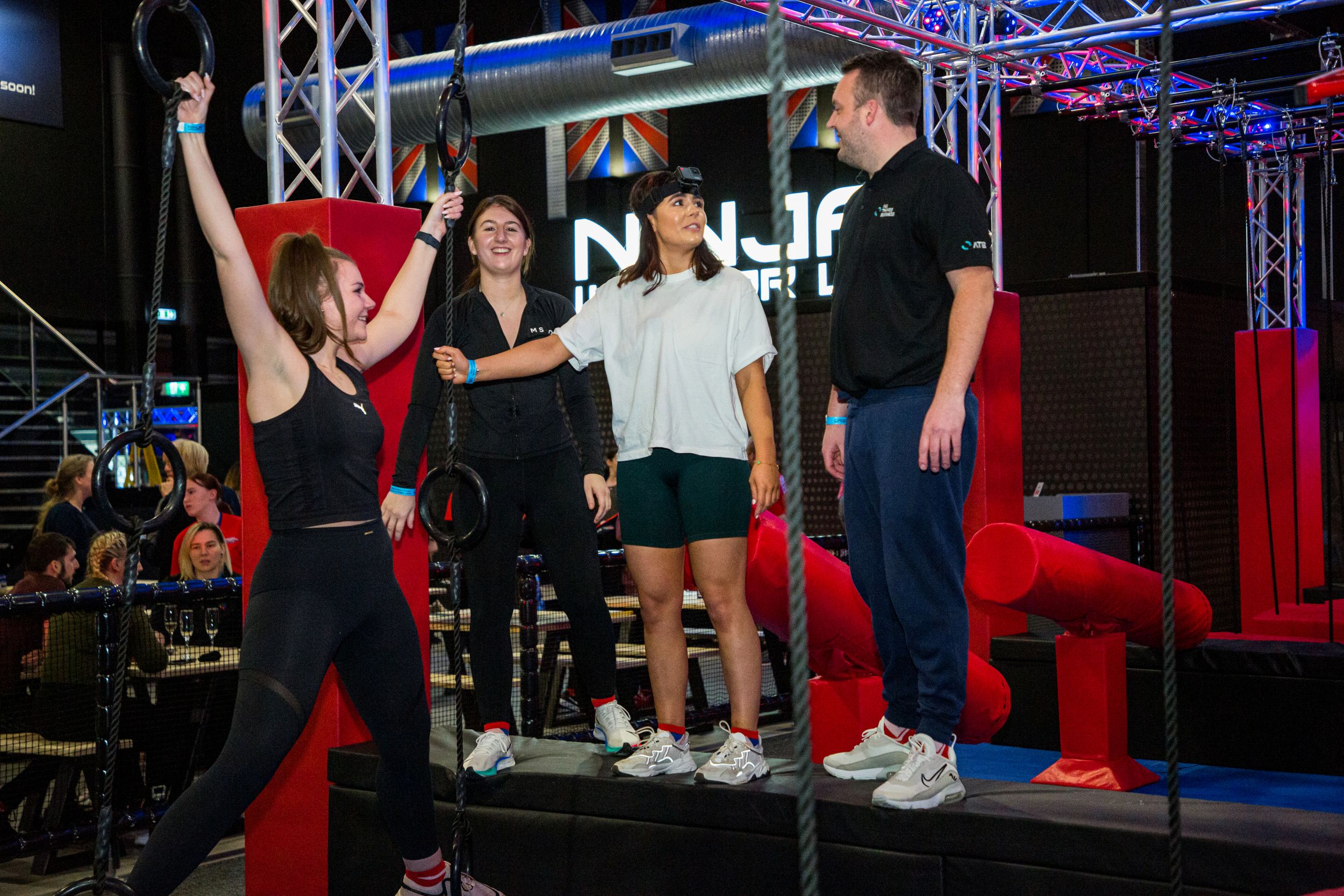 Group of people enjoying an indoor adventure park course