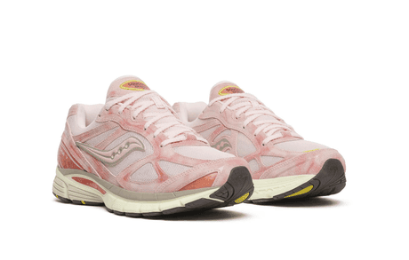 Pair of pink running shoes with white soles on white background